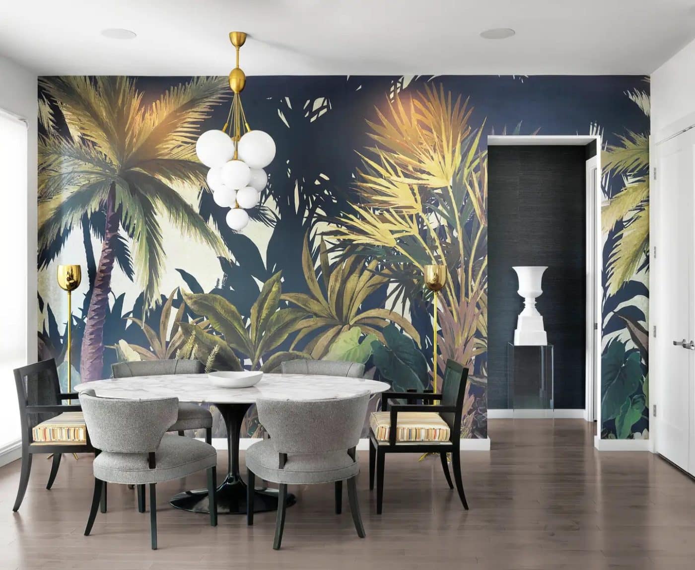 A St. Louis dining room designed by Jacob Laws with a tropical-print wallpaper mural 