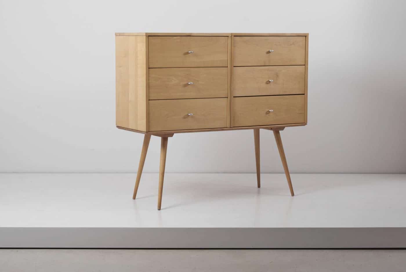 A light maple chest of drawers designed by Paul McCobb with aluminum drawer pulls