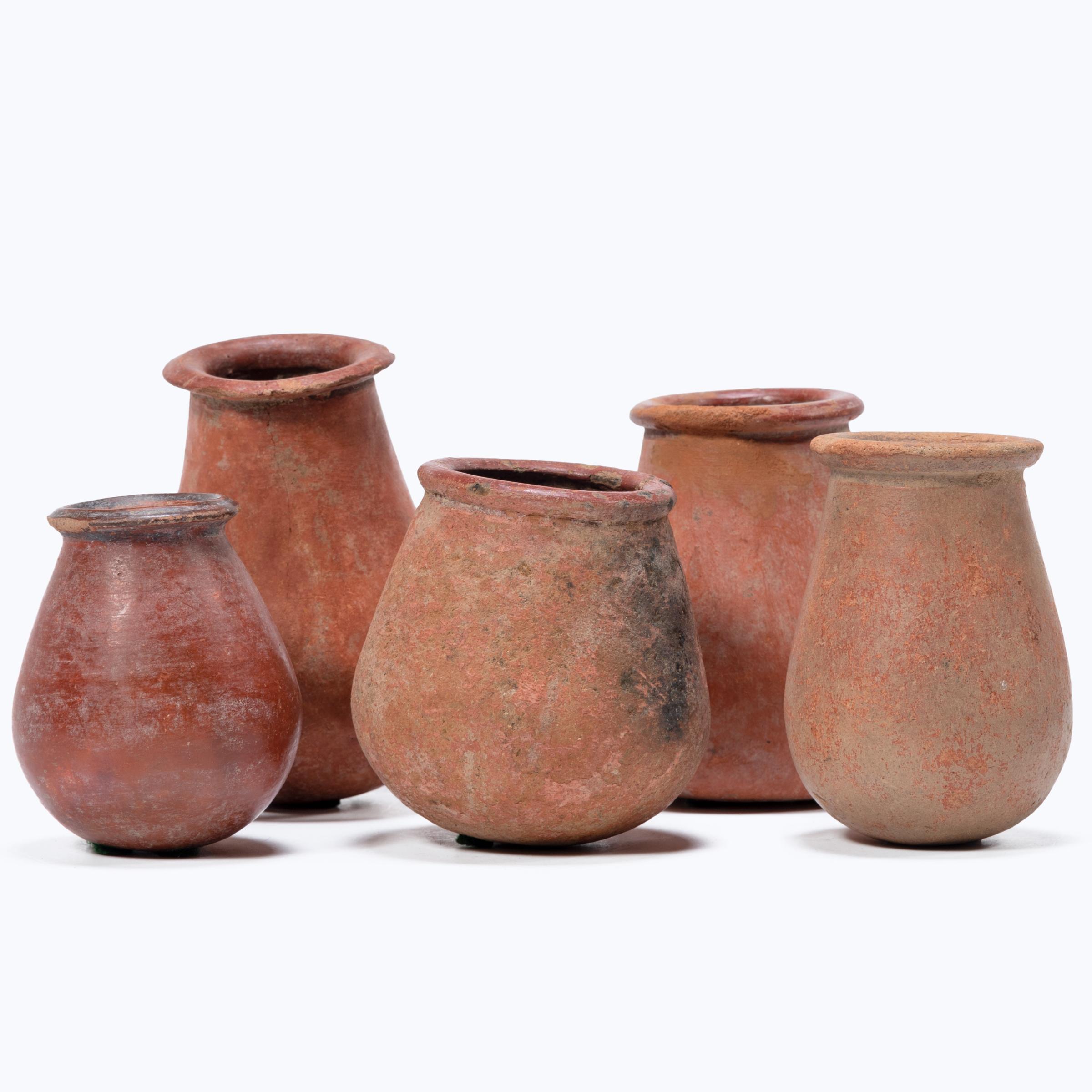 A grouping of five small African redware vessels