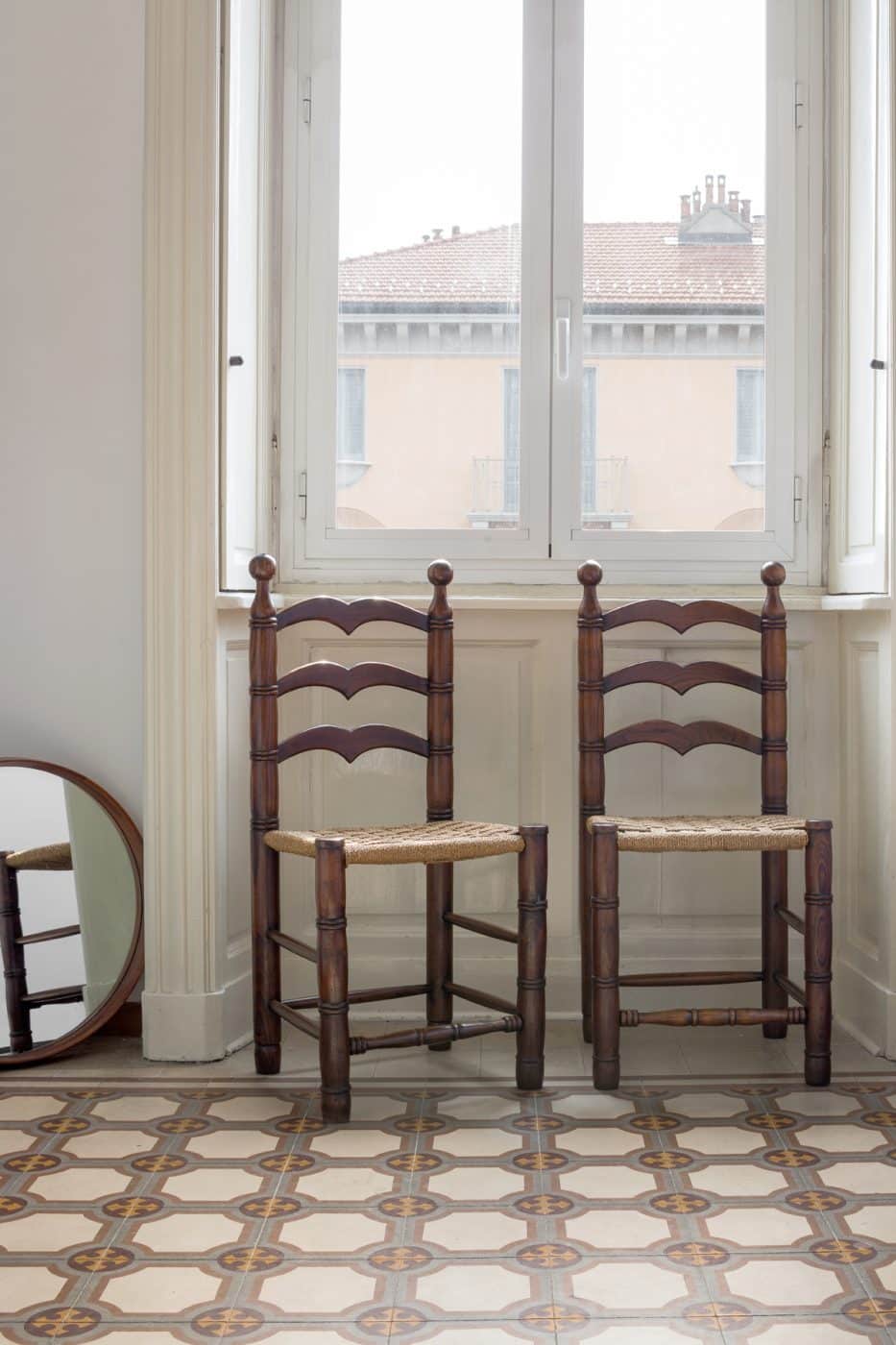 A pair of 1950s Calligaris oak chairs by the window in Jenny Walton's apartment