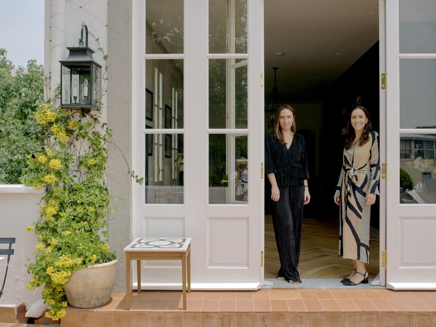 Sophia and Fernanda Loyzaga in the doorway leading to the terrace outside their third-floor showroom