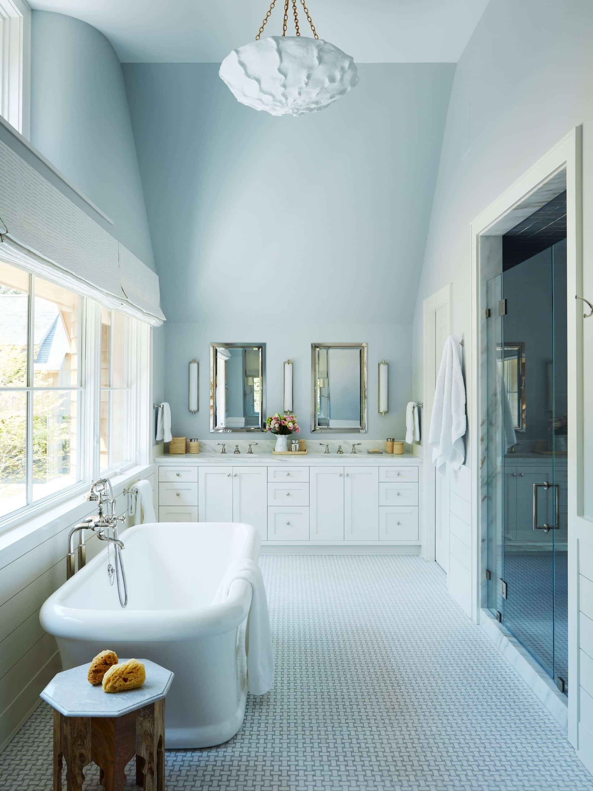 blue and white bathroom with tub by Carrier and Company