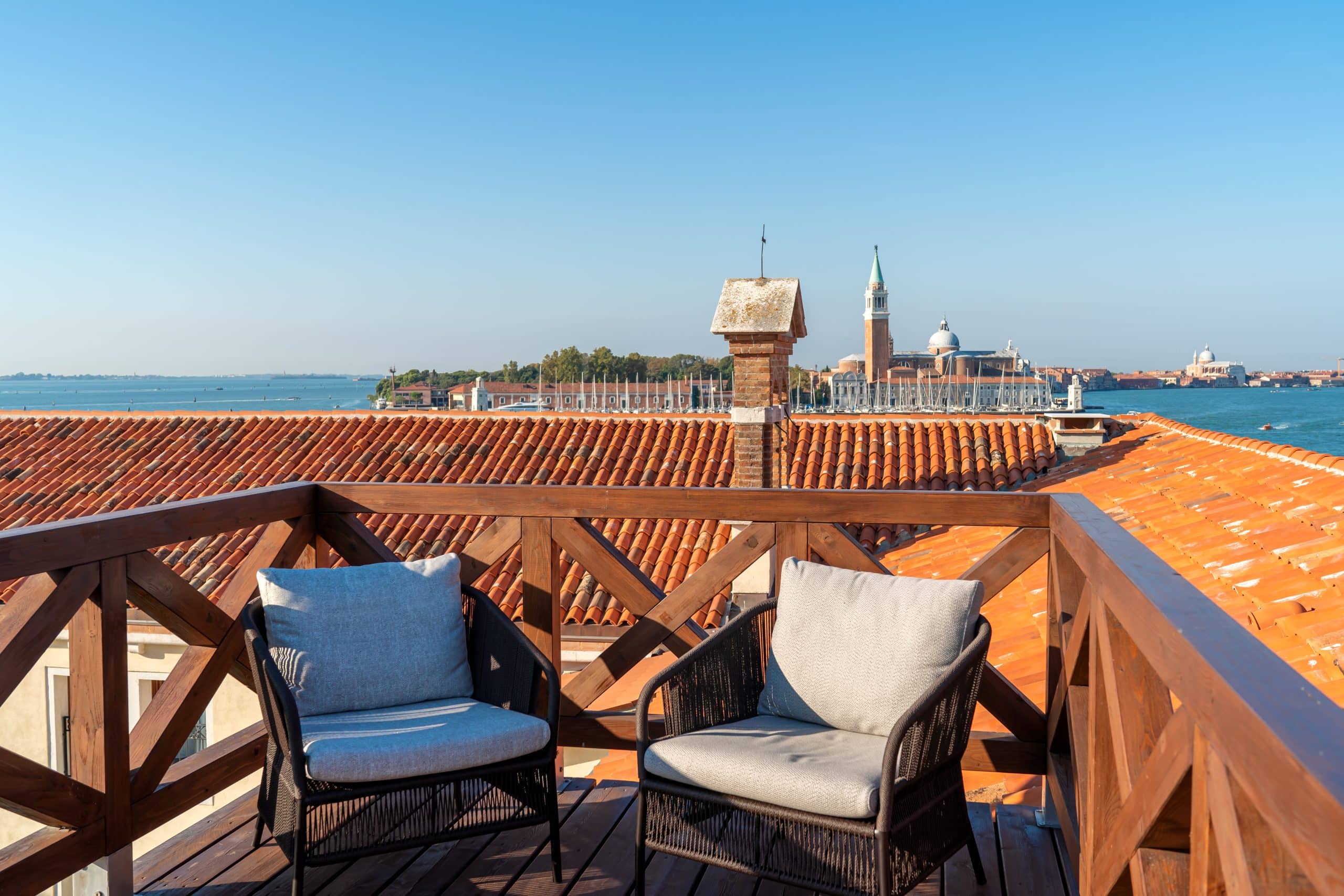 Venice's new Ca' di Dio hotel roof terrace of Altana Suite with view of San Maggiore monastery on its island across the Grand Canal. 
