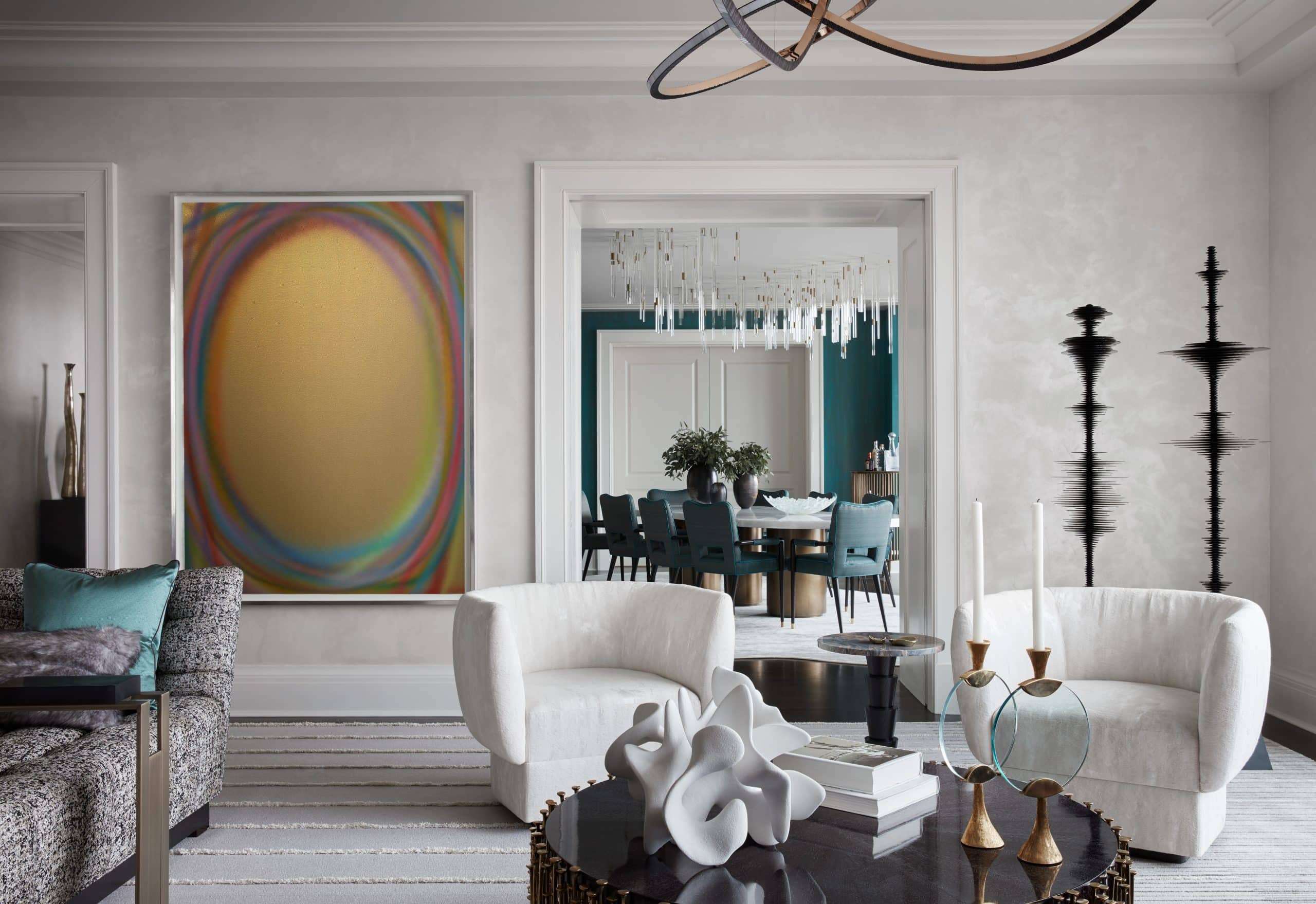 Living room of Manhattan apartment designed by Drake/Anderson's Caleb Anderson Jamie Drake with pair of curving white chairs, gray day bed, contemporary art