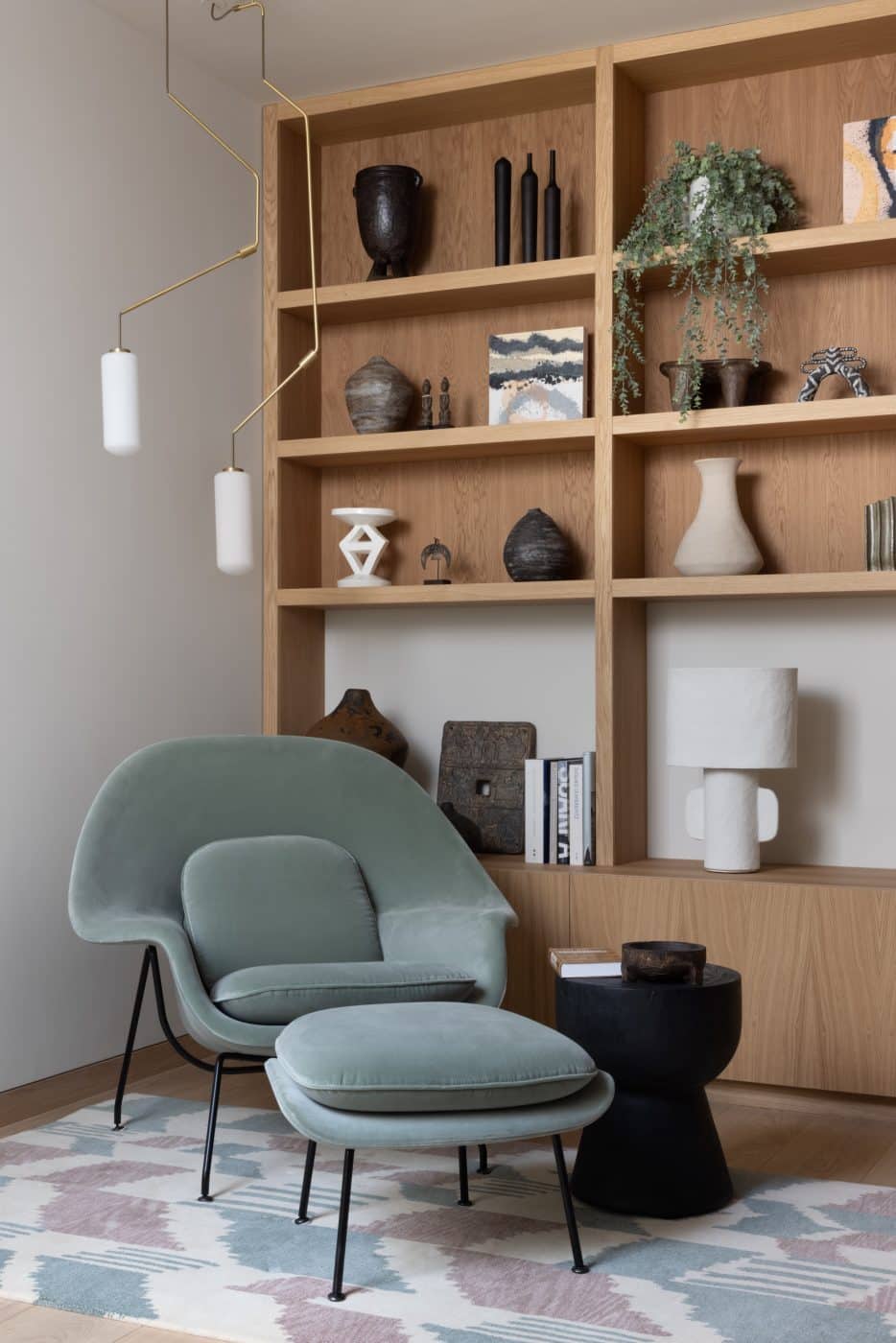 basement study with custom shelving and Eero Saarinen Womb chair