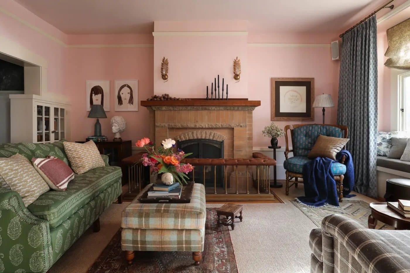 A living room with muted pink walls and traditional furnishings in a variety of patterns.