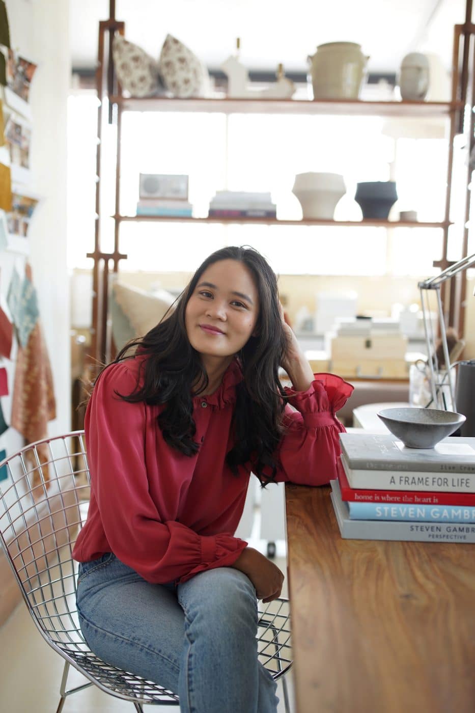 Lynn Kloythanomsup of Landed Interiors & Homes seated at desk in her Berkeley, California, office