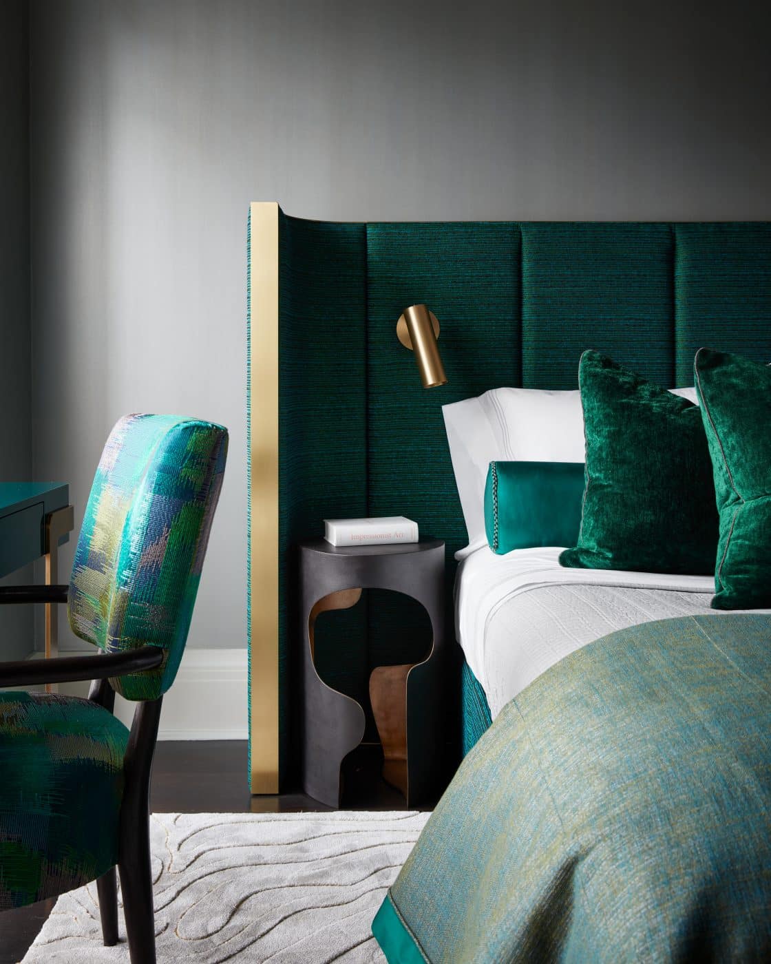 Emerald-hued guest bedroom of Manhattan apartment designed by Drake/Anderson's Caleb Anderson Jamie Drake with curving headboard and nightstands