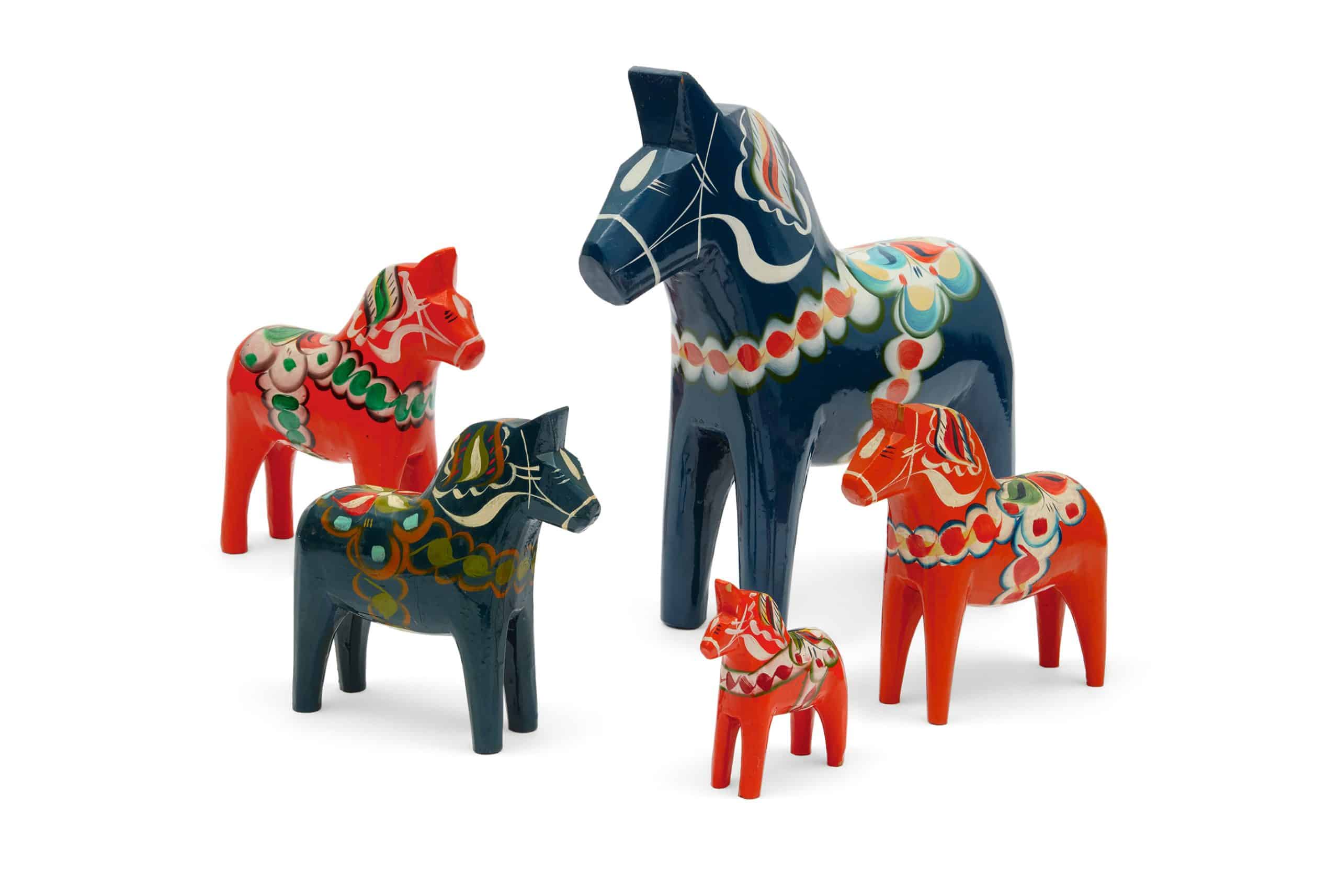 Red and blue Swedish Dala horse toys of various sizes