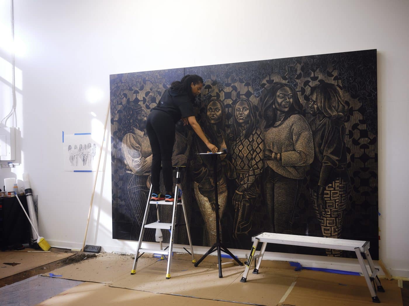 Artist LaToya M. Hobbs work on a woodcut panel in her Baltimore, MD, studio