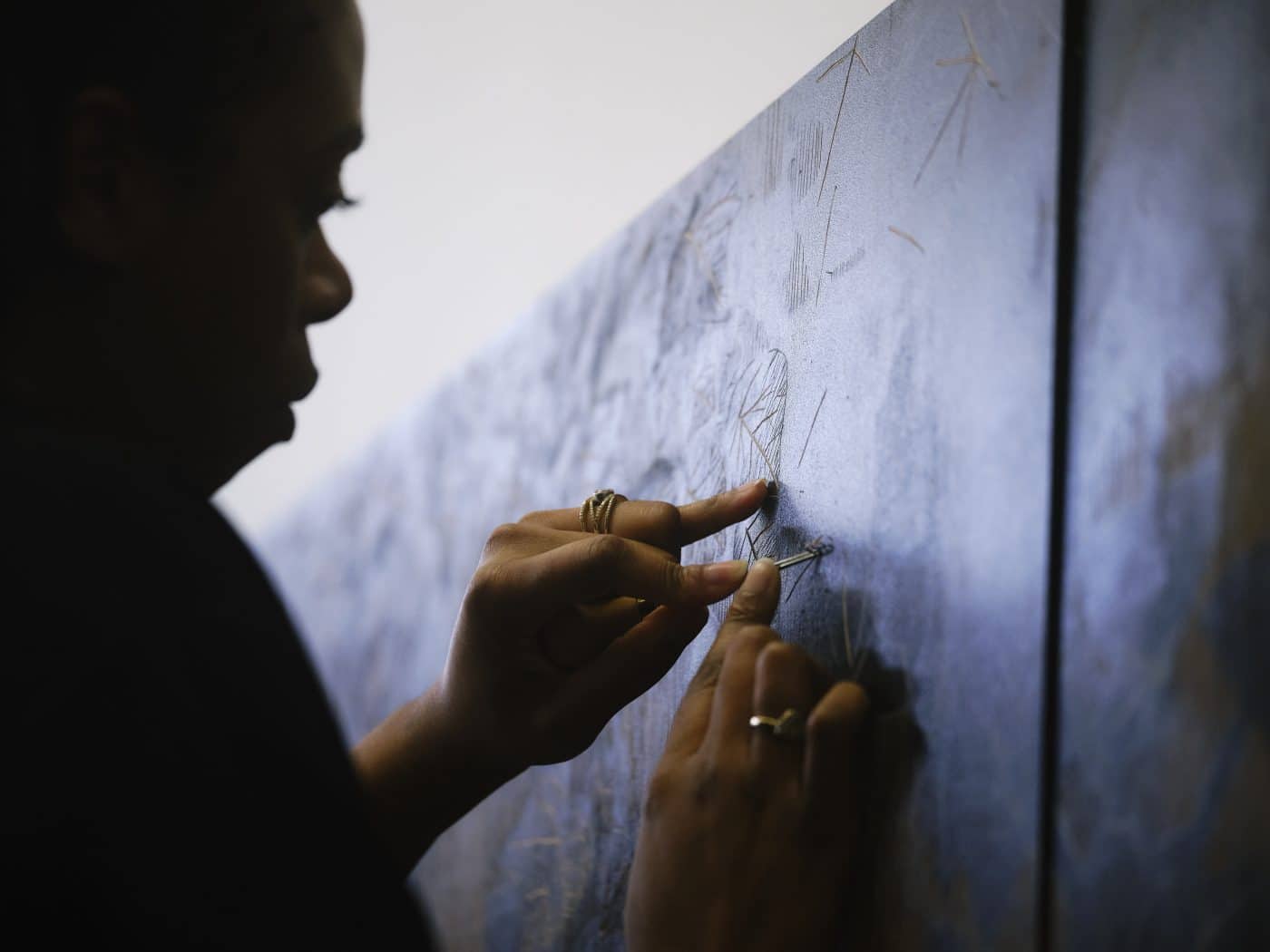 Artist LaToya M. Hobbs work on a woodcut panel in her Baltimore, MD, studio