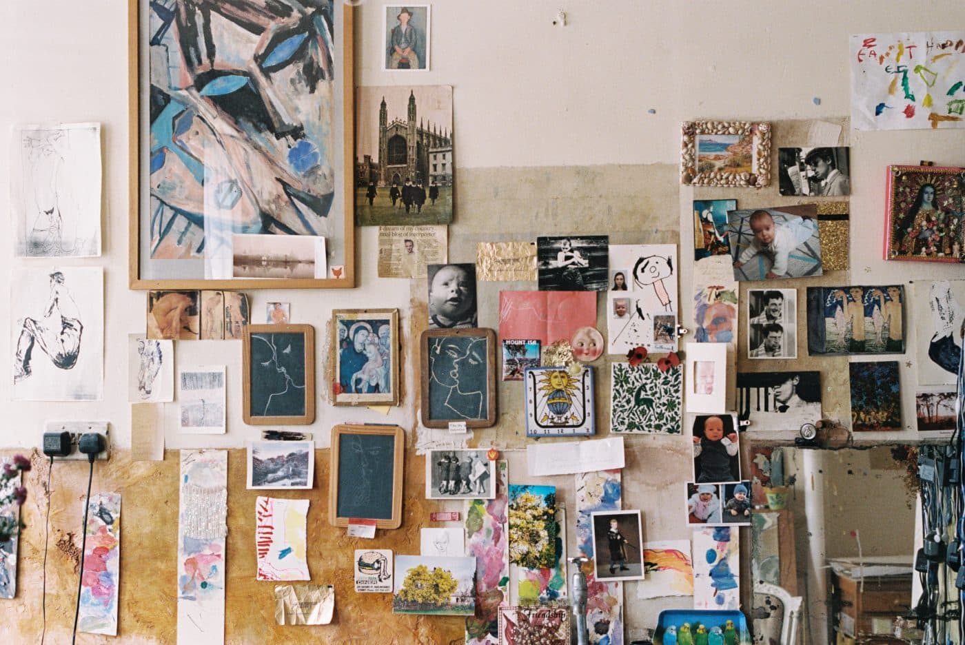 wall covered in photos and artwork in Howard Tangye's studio