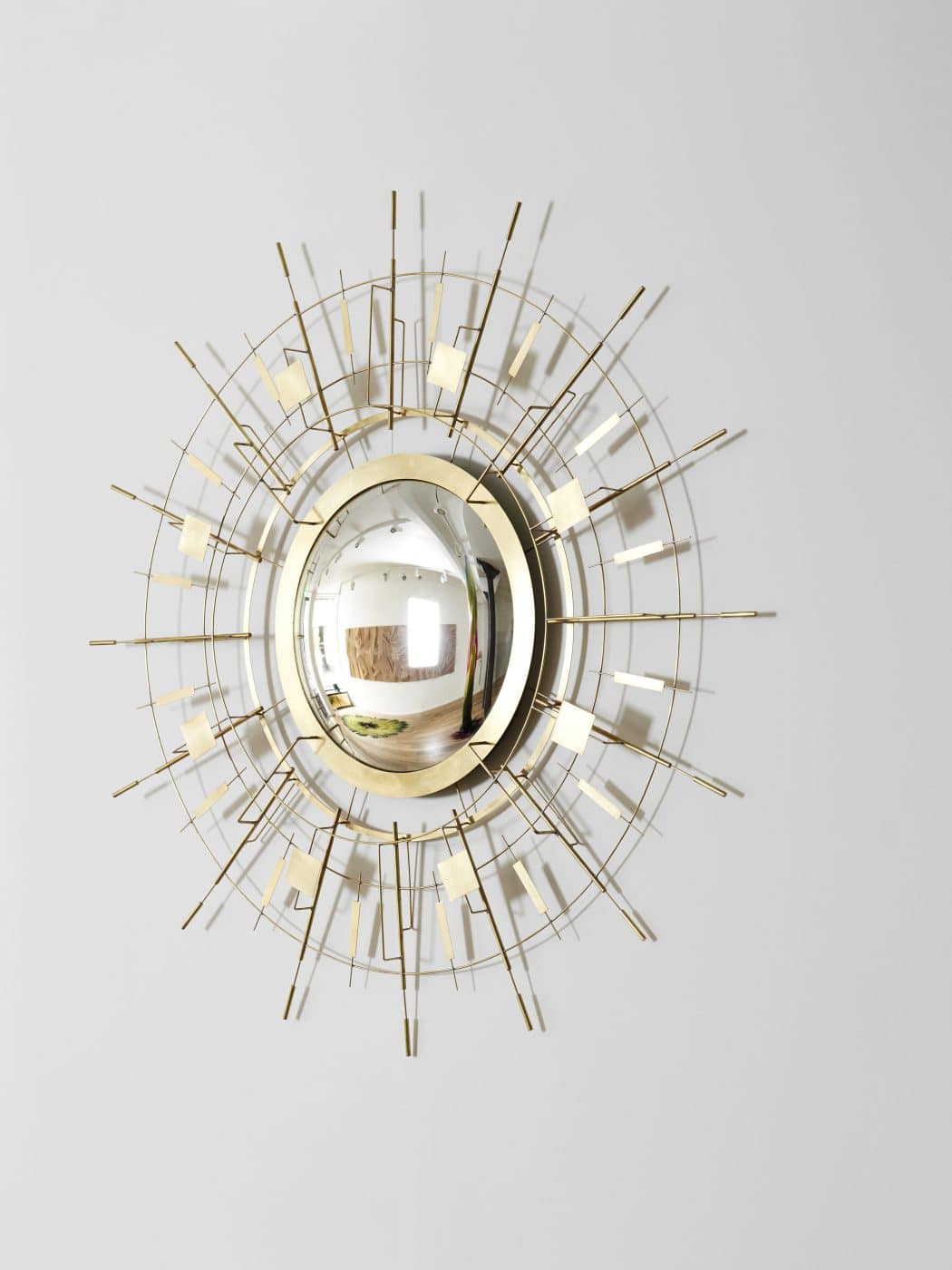 A brass sunburst mirror by Éric de Dormael at Galerie Negropontes