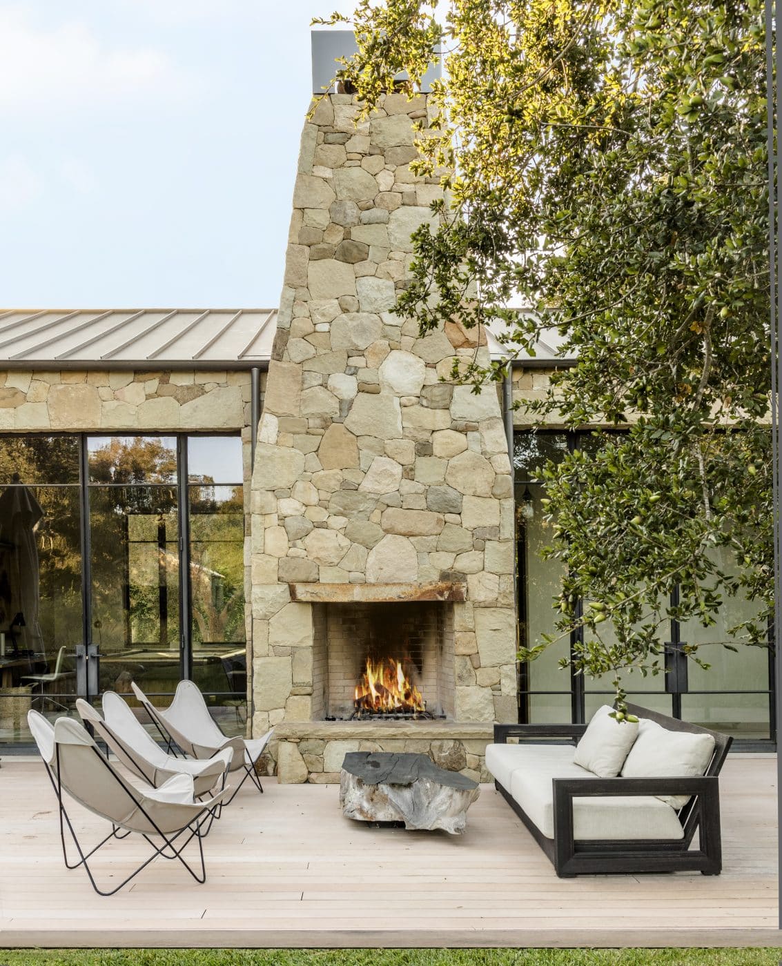 Outdoor living area in front of large alfresco fireplace at the home of architect William Hefner from Montecito Style: Paradise on California’s Gold Coast Phaidon Monacelli Press book 