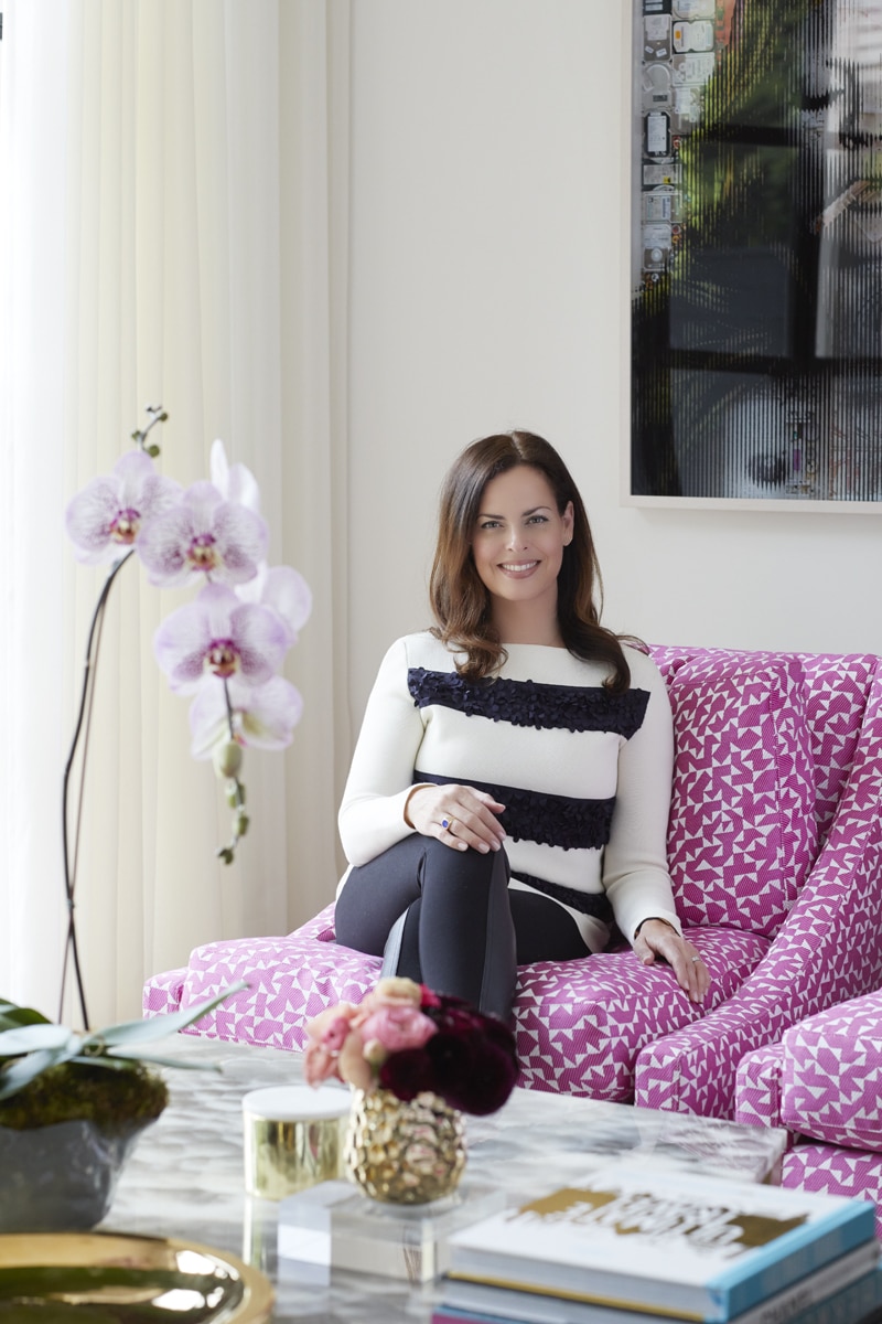 Toronto-based interior designer Anne Hepfer portrait on pink chair