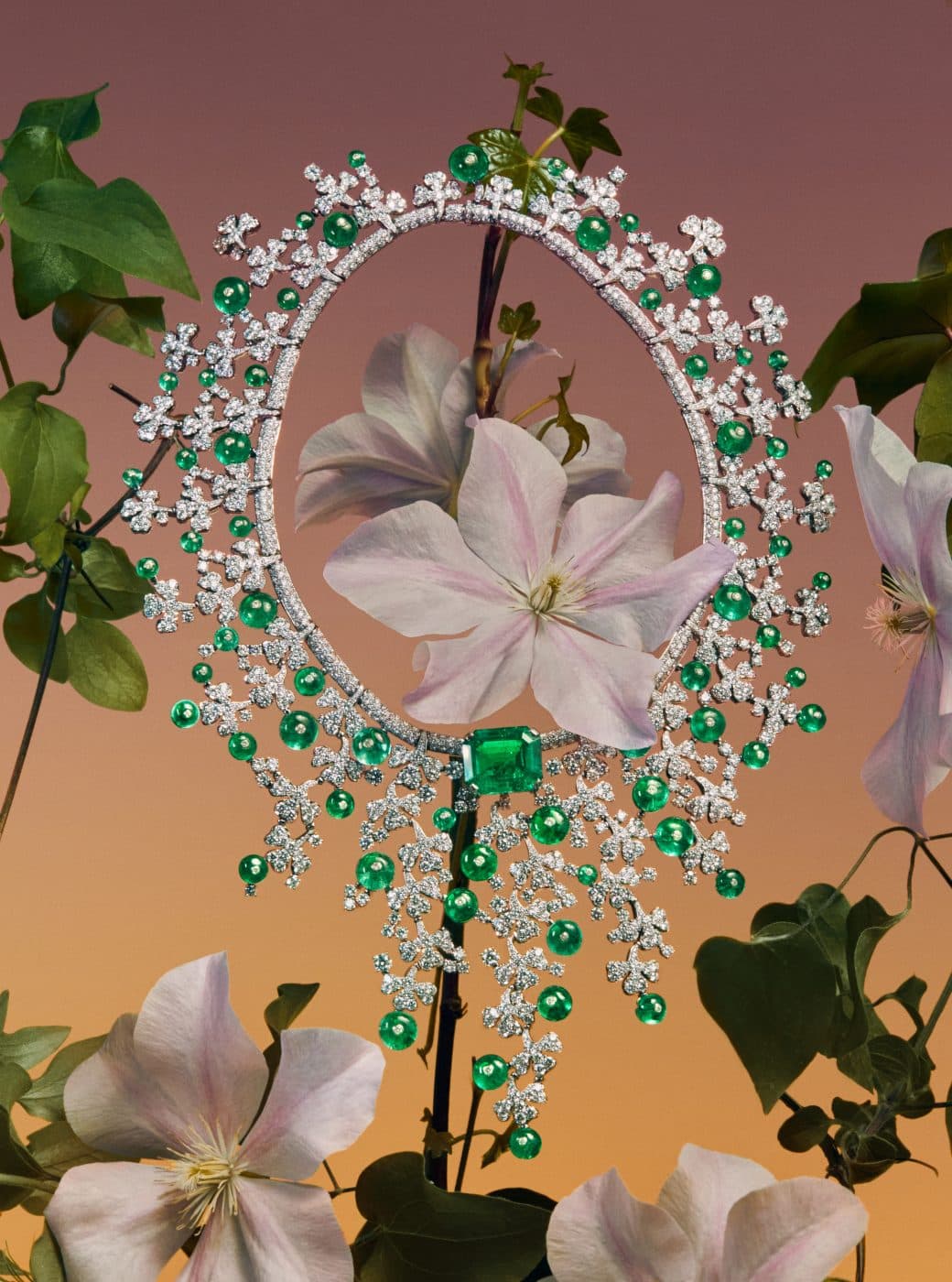 Bulgari necklace of emeralds and diamonds photographed surrounding a flower as seen in Rizzoli book Bvlgari Eden: The Garden of Wonders