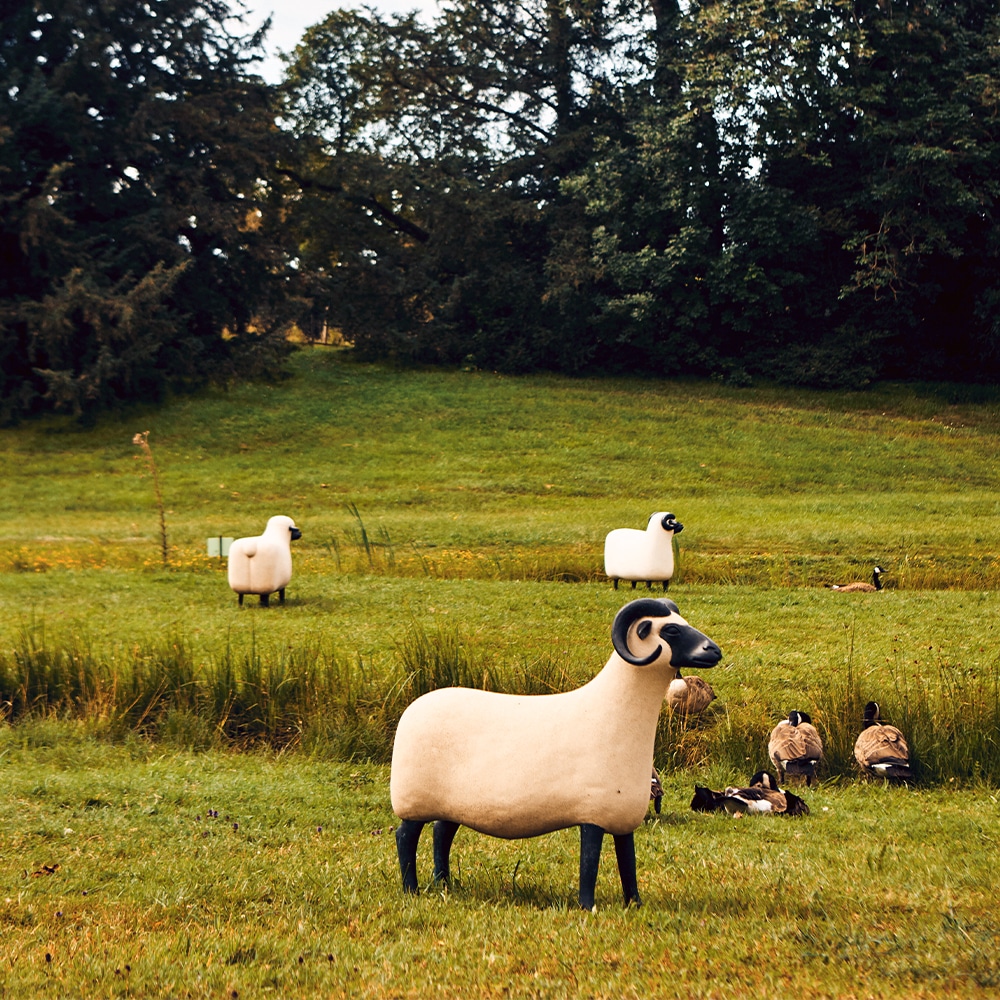 sheep moutons sculptures statues in a green meadow by French artists and designers Claude and François-Xavier Lalanne Assouline book Lalanne: A World of Poetry