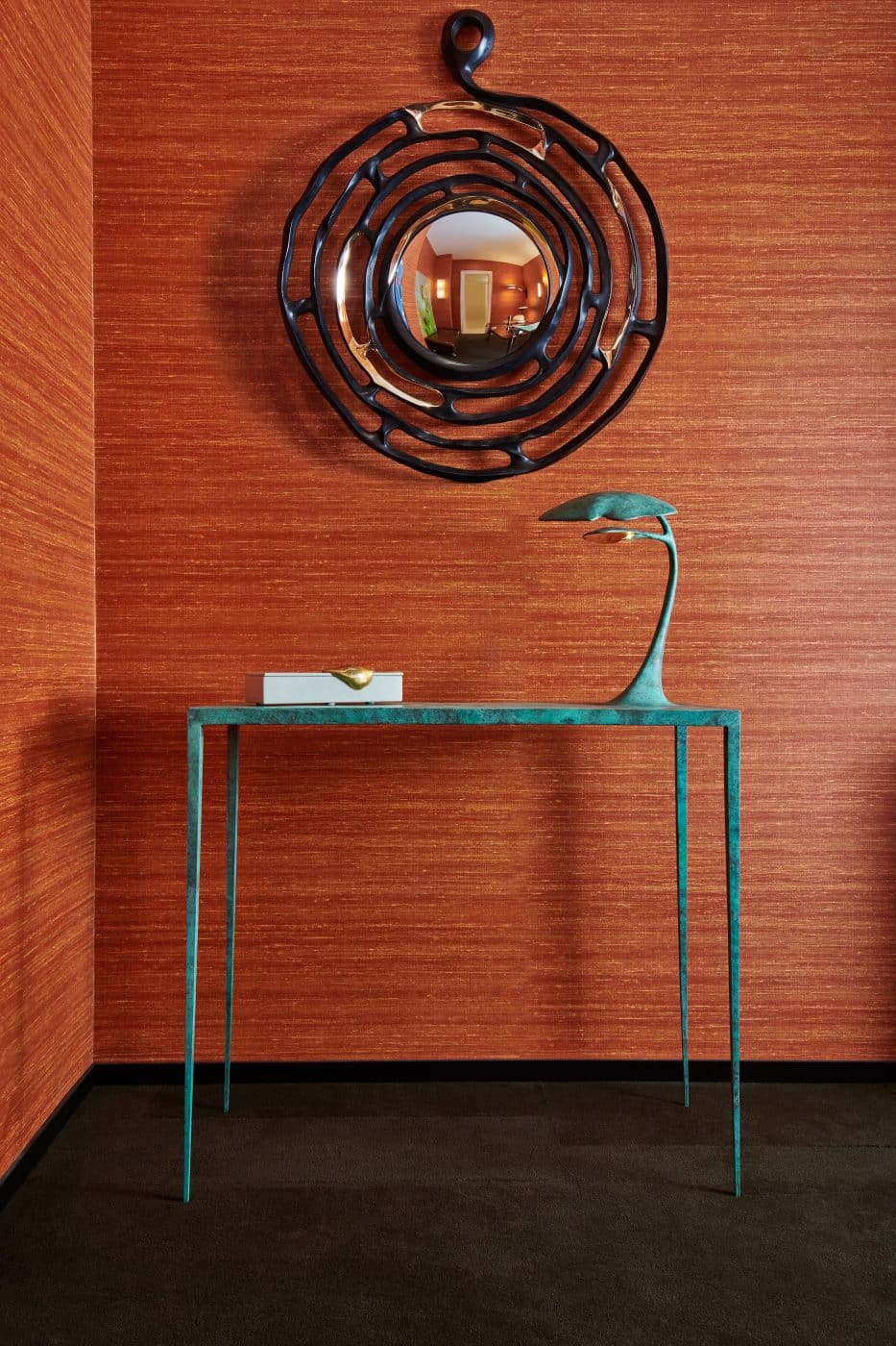 A console table and mirror in the room for lighting displays in the Achille Salvagni Atelier on Madison Avenue in New York