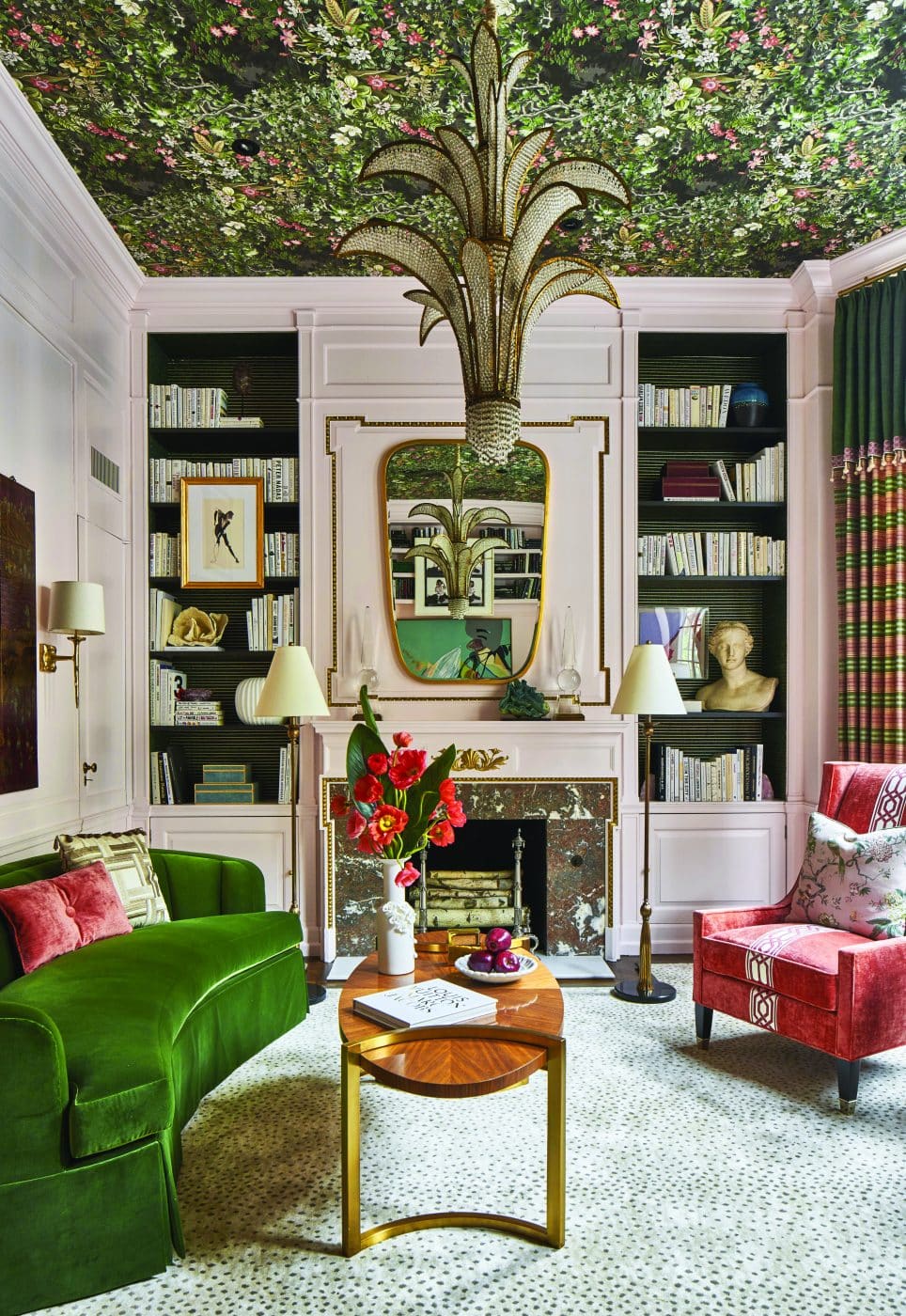 Corey Damen Jenkins ladies' library at Kips Bay Decorator Show House in New York in 2019 with jungle wallpaper ceiling, pink walls, pink and green furniture, marble fireplace