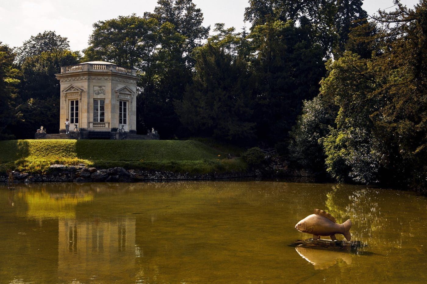 Golden carp statue in a pond at Versailles by French artist and designer François-Xavier Lalanne Assouline book Lalanne: A World of Poetry