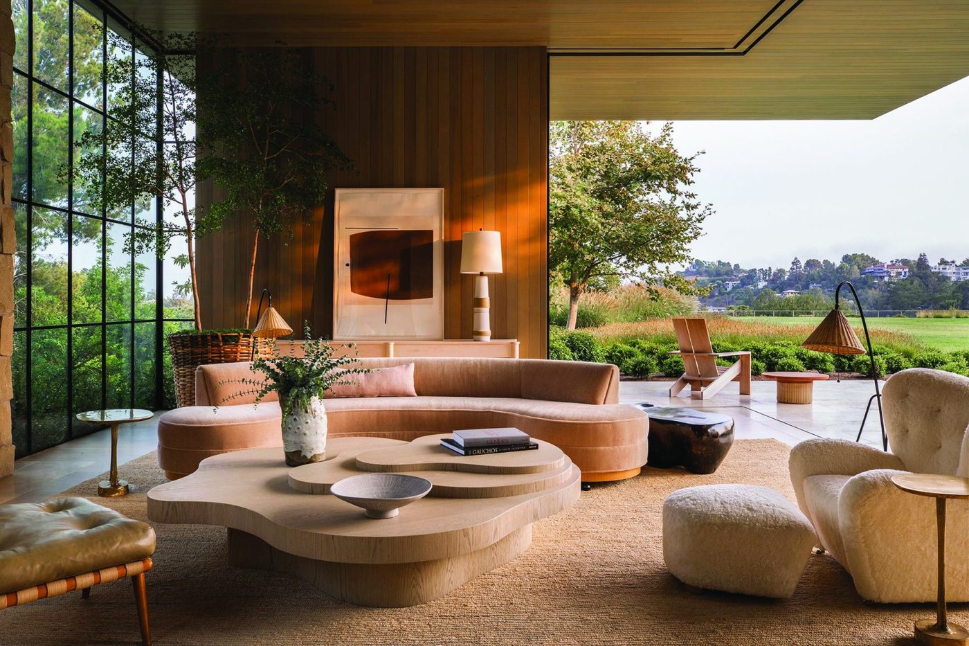 Indoor outdoor living room by Jamie Bush + CO in Los Angeles's Mandeville Canyon with retractable wall of glass open on corner and furniture by Henge, Flemming LAssen and T.H. Robsjohn-Gibbons