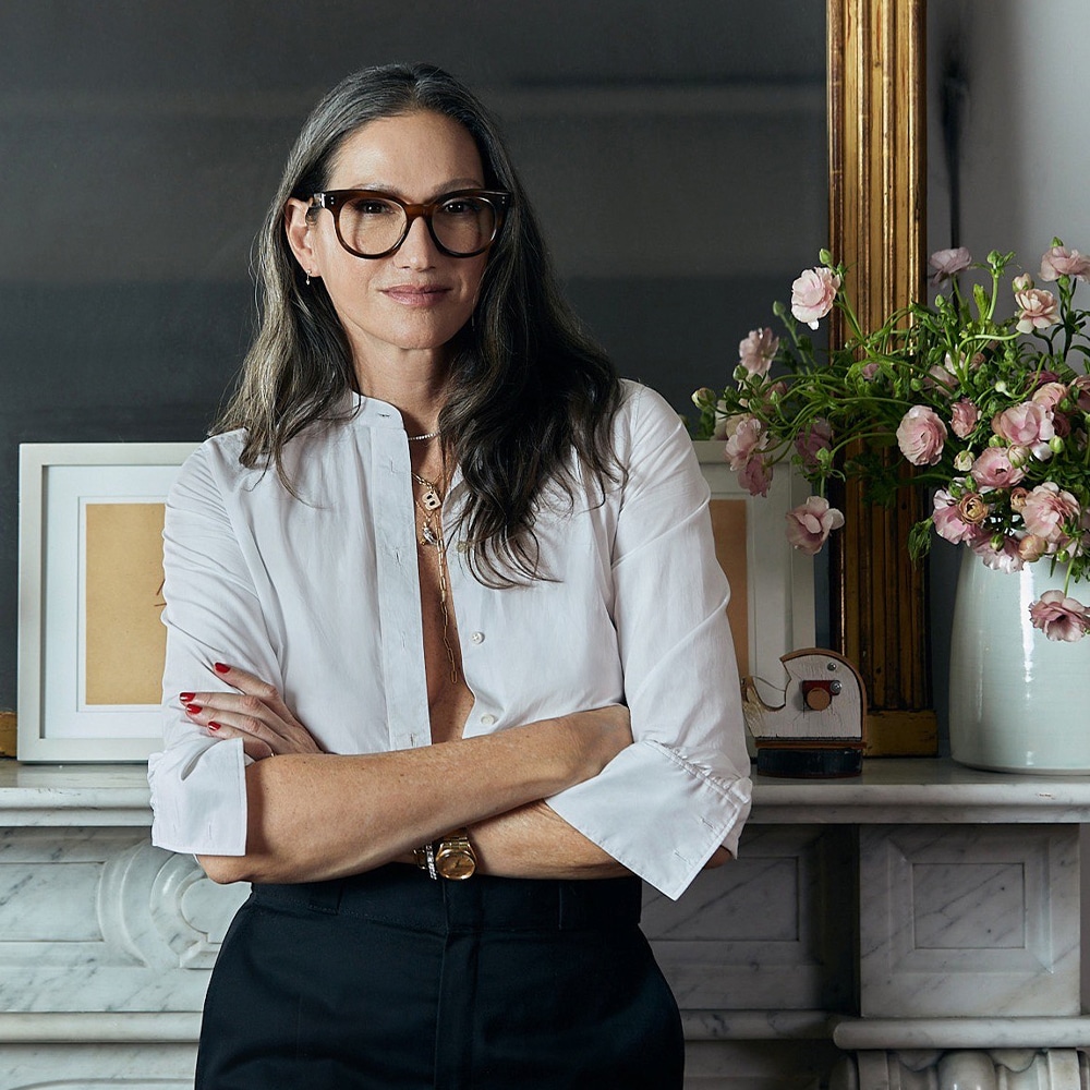 Jenna Lyons leaning against the mantel in the living room of her Soho loft