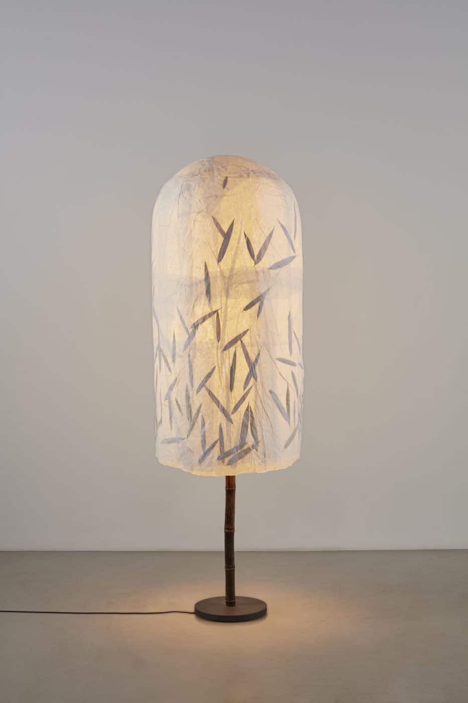A floor lamp by Andrea Branzi with a tall, domed shade made of rice paper with embedded bamboo leaves