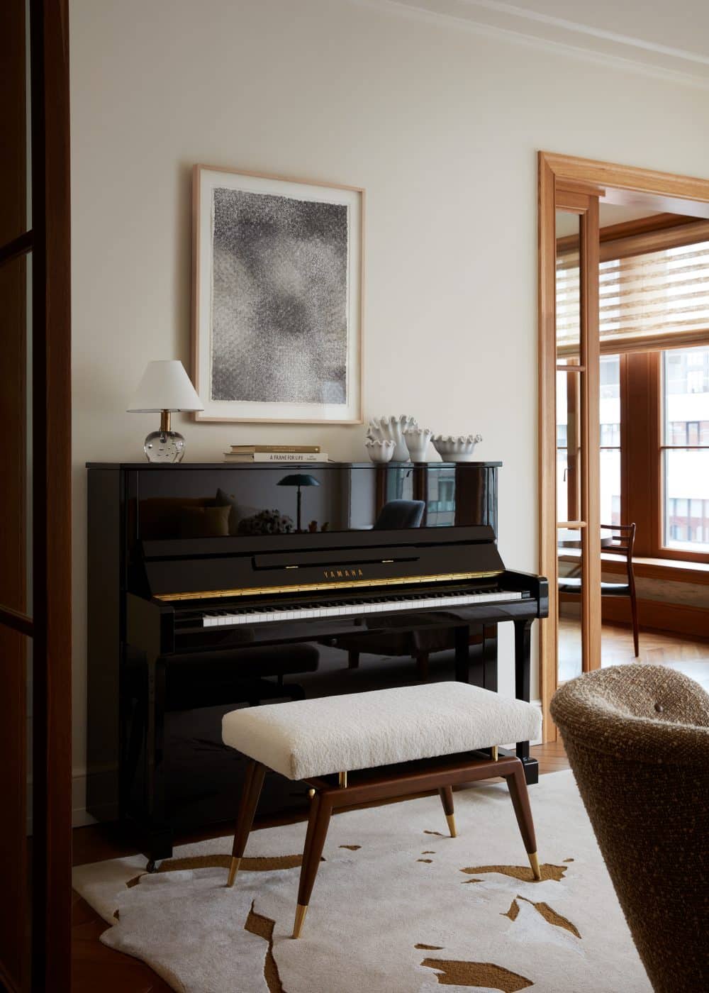 Living room piano nook of apartment in Fitzroy building in New York City by interior designer Shawn Henderson