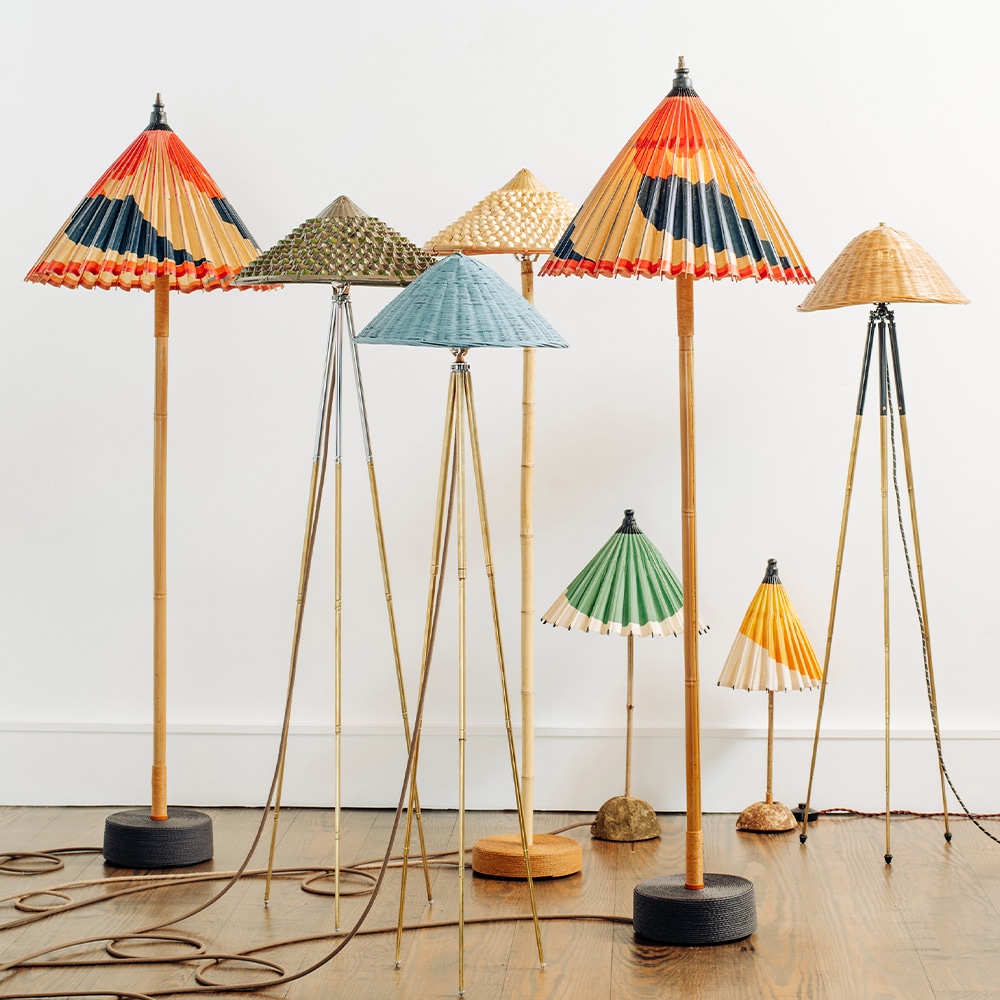 Eight Tennant New York lamps of varying heights with colorful vintage parasol shades