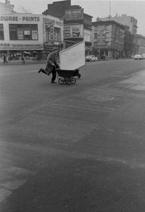 Artist Red Grooms (born Charles Rogers Grooms) smiles as he pushes a large canvas in a baby carriage across Third Avenue, New York, late 1950s. (Photo by John Cohen/Getty Images)