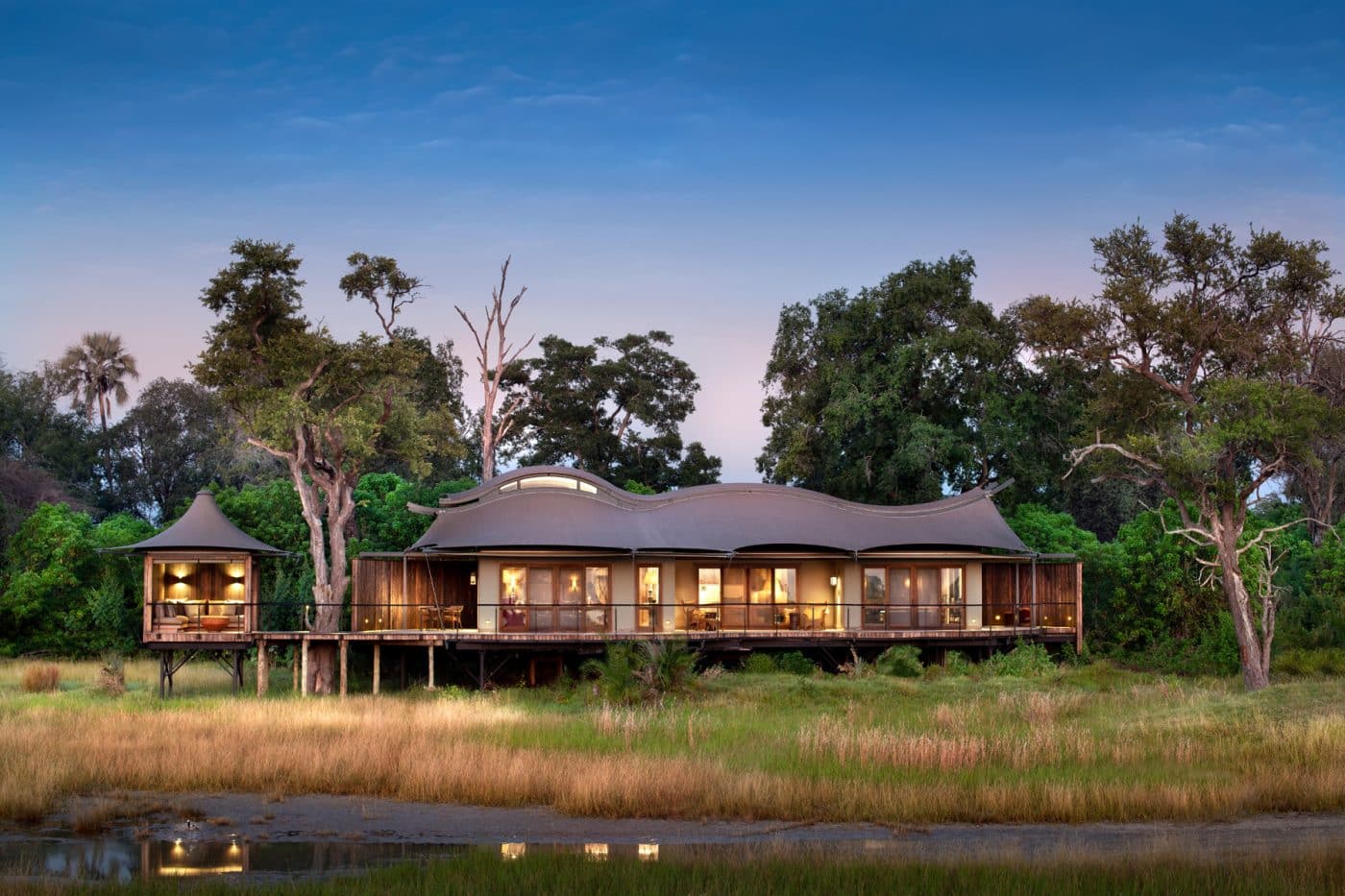 Architect Anton de Kock designed the entire Xigera Safari Lodge, including each of its 12 individually designed suites (an example of which appears above). He wanted the buildings to be in synergy with their surroundings, using torched timber cladding and undulating roofs inspired by the wingspan of the region’s rare Pel’s fishing owl. 