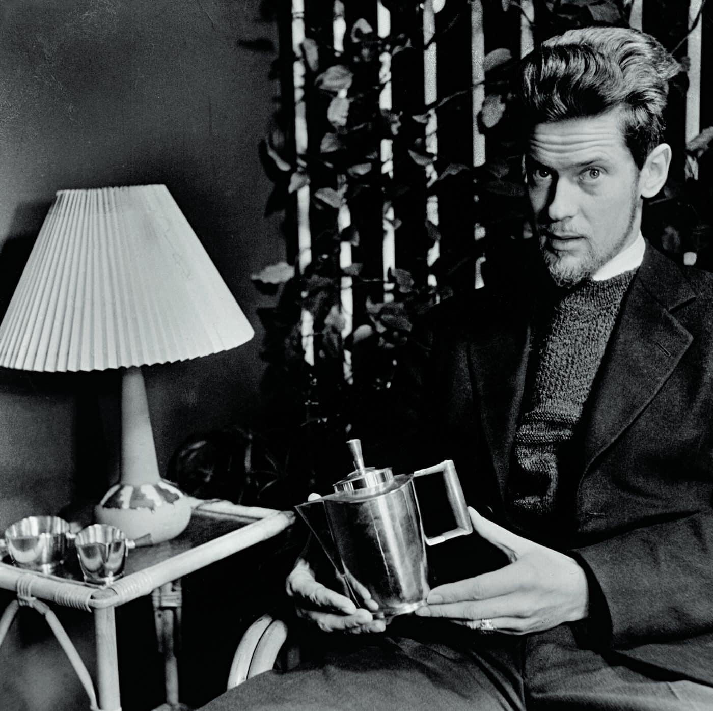 A 1947 portrait of Jens Quistgaard with a coffee pot he designed.