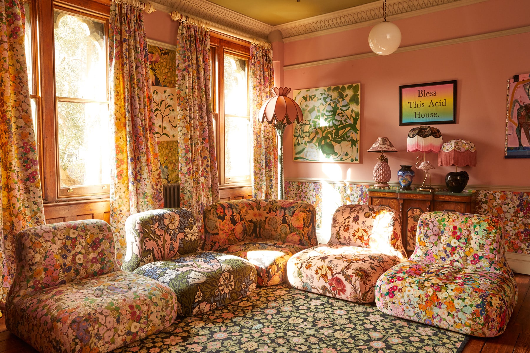 A room at House of Hackney's London flagship furnished with the brand's wallpaper, curtains, rug, lighting and seating in a variety of floral prints