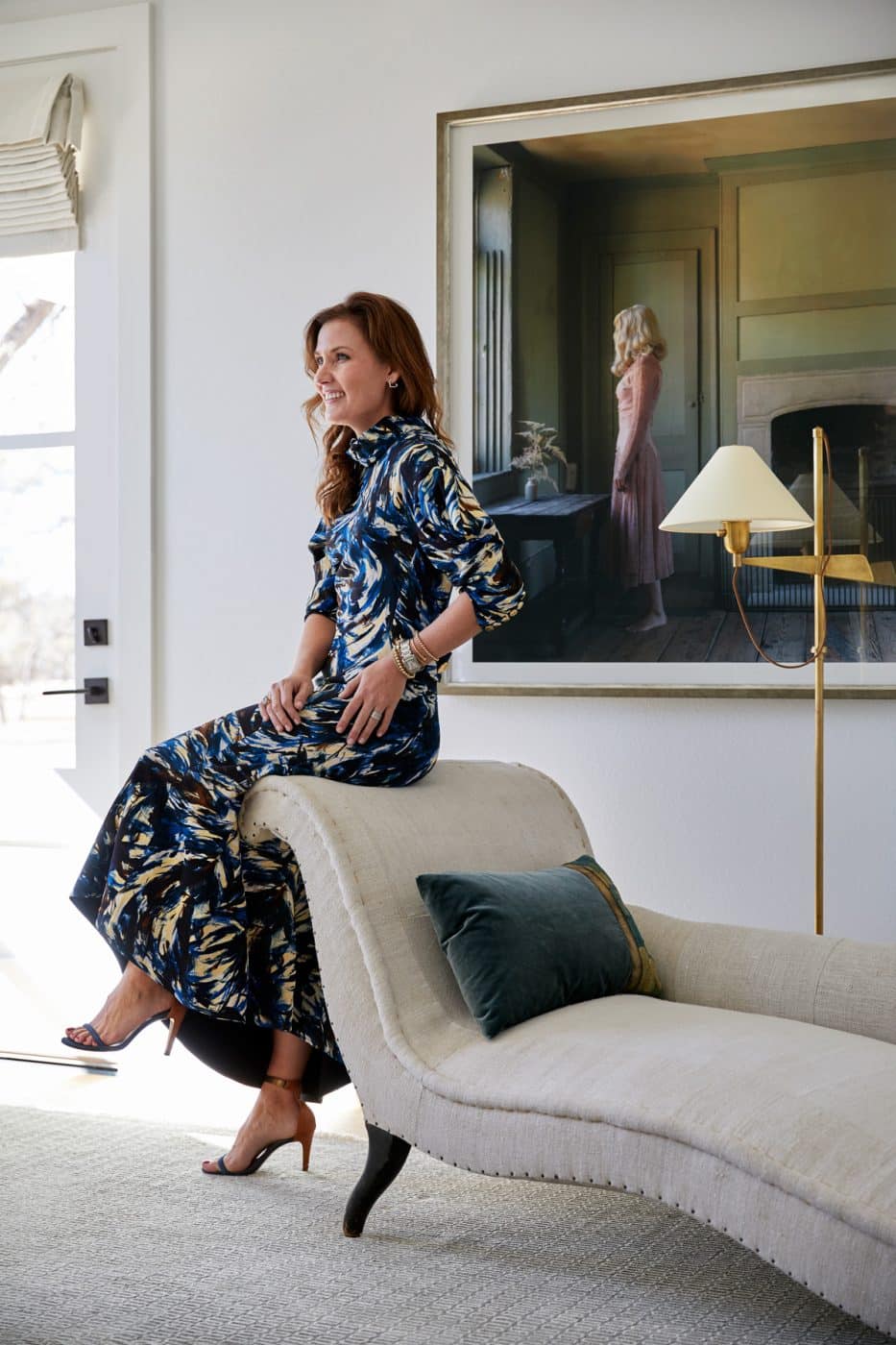 In a house she designed in Texas Hill Country, Houston-based Meg Lonergan rests on a Napoleon III chaise lounge underneath an Anja Niemi photograph. 