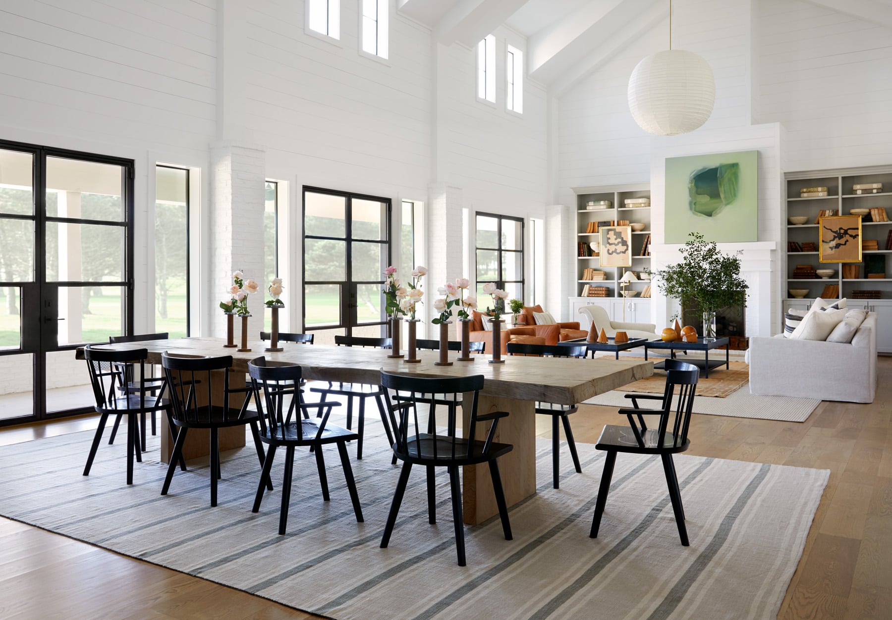 In the dining area are a live-edge cedar table, chairs by O & G Studio and an Isamu Noguchi light sculpture from the Noguchi Museum store.