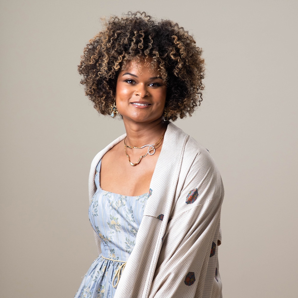 Journalist and trans activist Raquel Willis in a patterned light-blue dress and cream-colored shawl