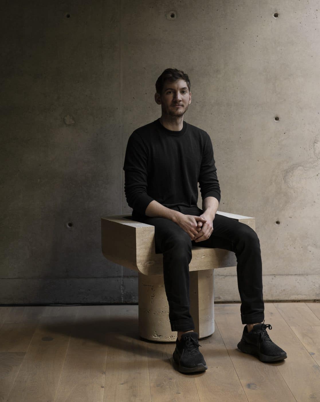 Monolith's Marc Personick in a travertine side chair