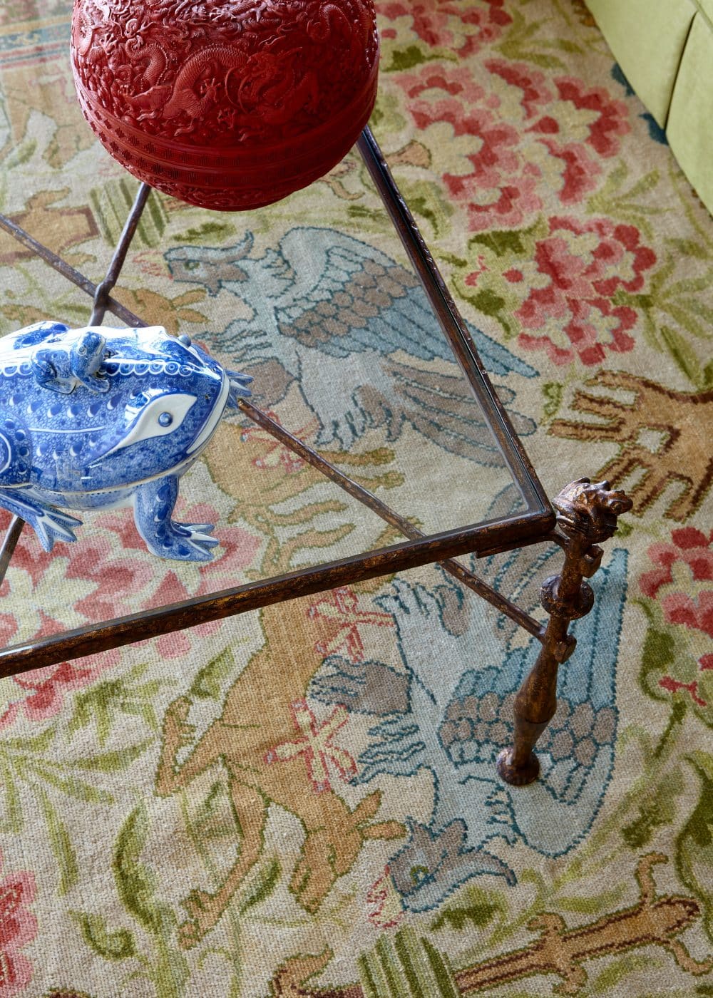 details of an 18th-century secretary with collectible objects; detail of ceramic frog, Chinese lacquer box, and Spanish carpet