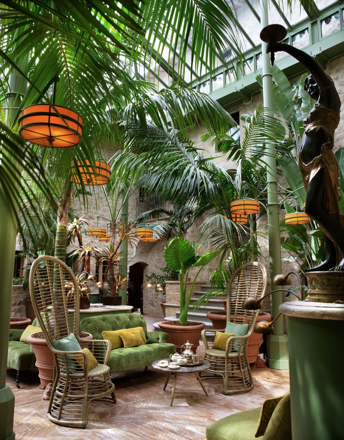 the glass-enclosed Palm Court at the Castello di Reschio hotel 