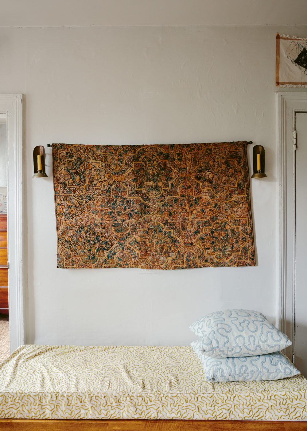 a view of  Camille Okhio’s Brooklyn apartment with a daybed and antique textiles