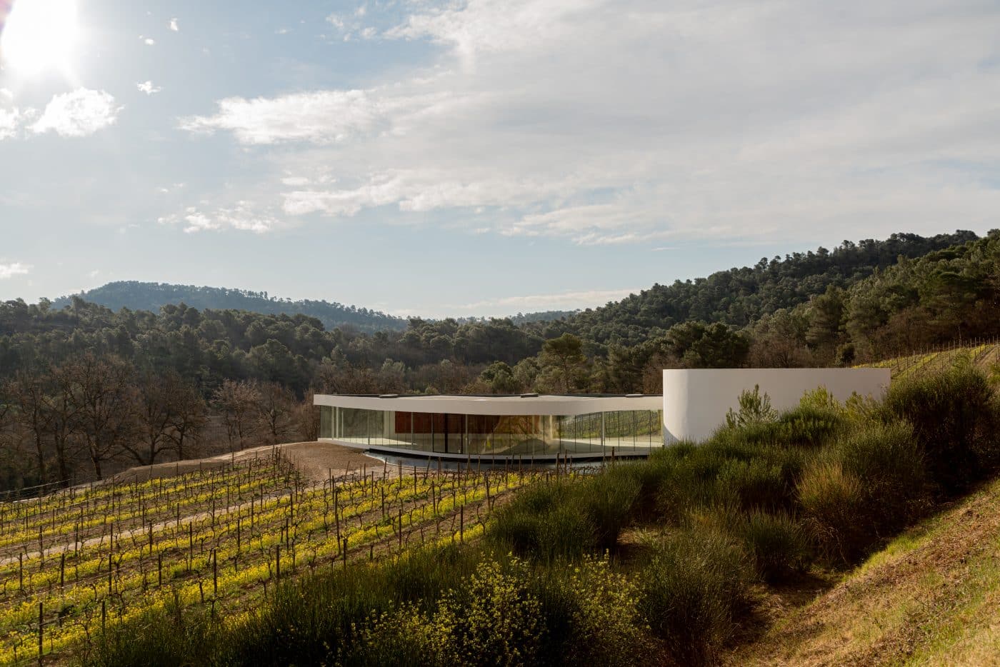 The glass-walled gallery of the Oscar Niemeyer Auditorium, the Brazilian architect's final project, designed in 2010. It's set in Château La Coste's vineyard.