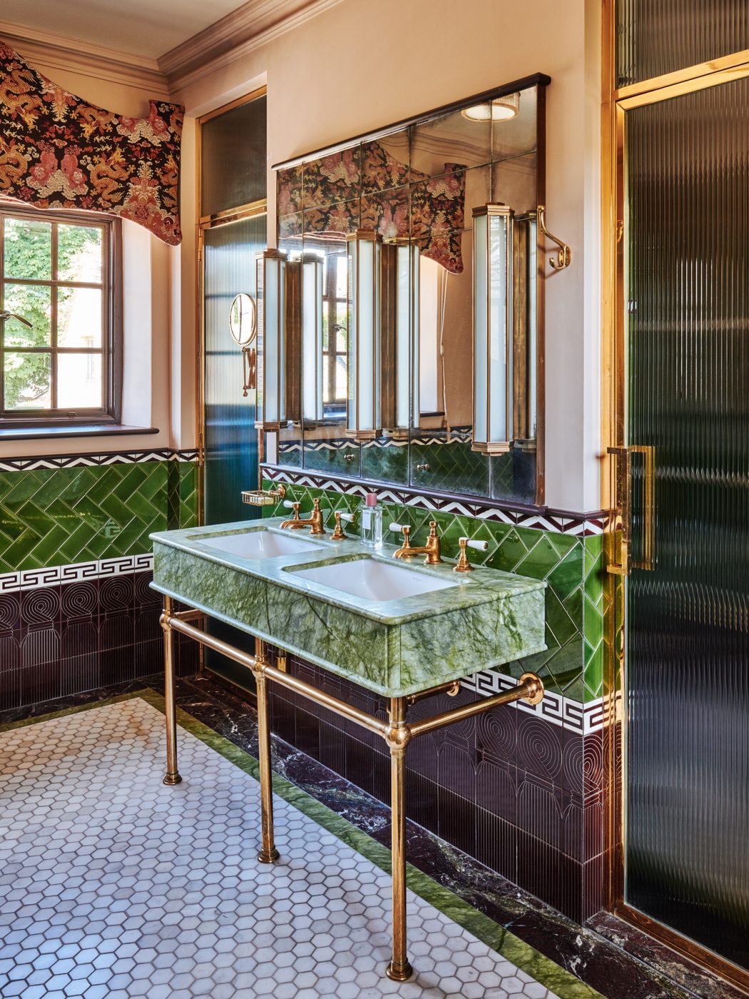 Cotswold House primary bathroom with green marble and green, purple and white tiles