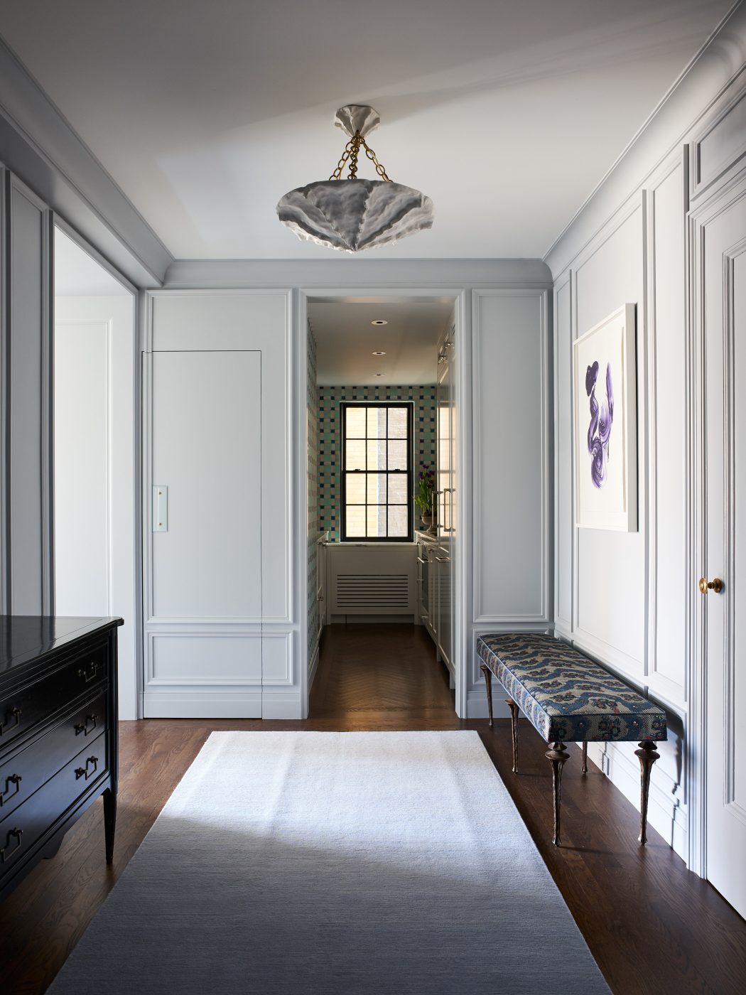 Foyer of Bennett Leifer's New York apartment with bench and pendant light.