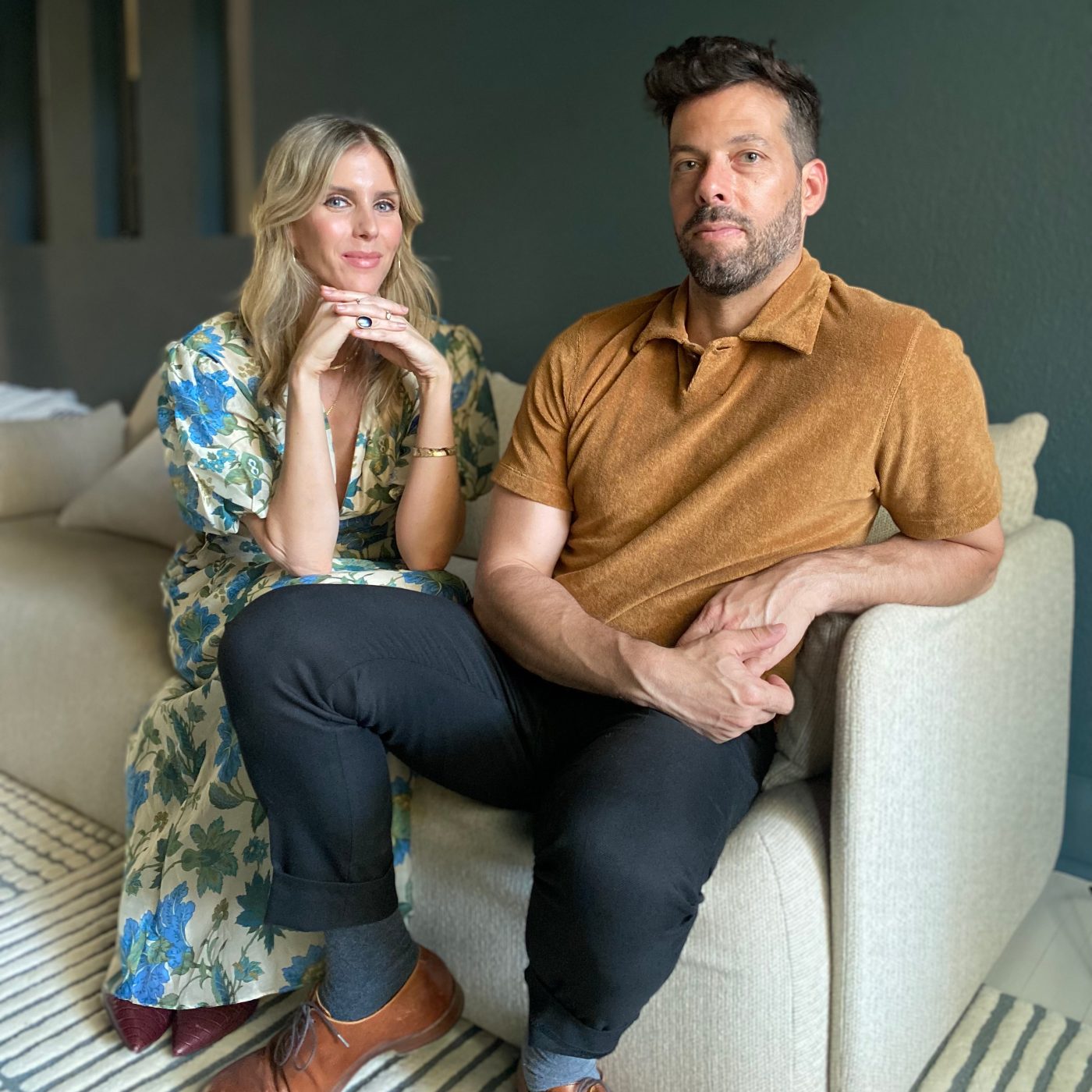 Annie Ritz and Daniel Rabin of And And And Studio, seated together on a cream sofa
