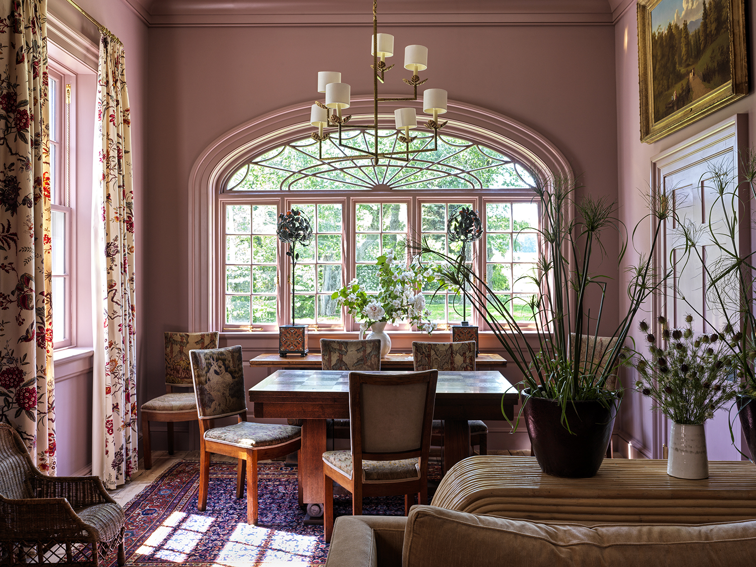 Parlor of an 18th-century farmhouse restored and designed by Hendricks Churchill with pink walls and vintage dining table and chairs
