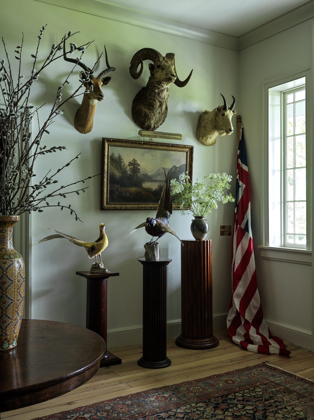 The foyer of an 18th-century farmhouse restored and designed by Hendricks Churchill, with a collection of taxidermy and antiques  