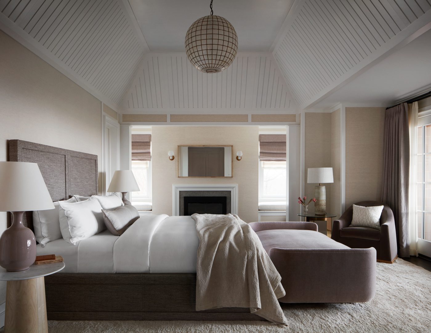 View of the primary bedroom in a Hamptons beach house designed by Charles & Co.