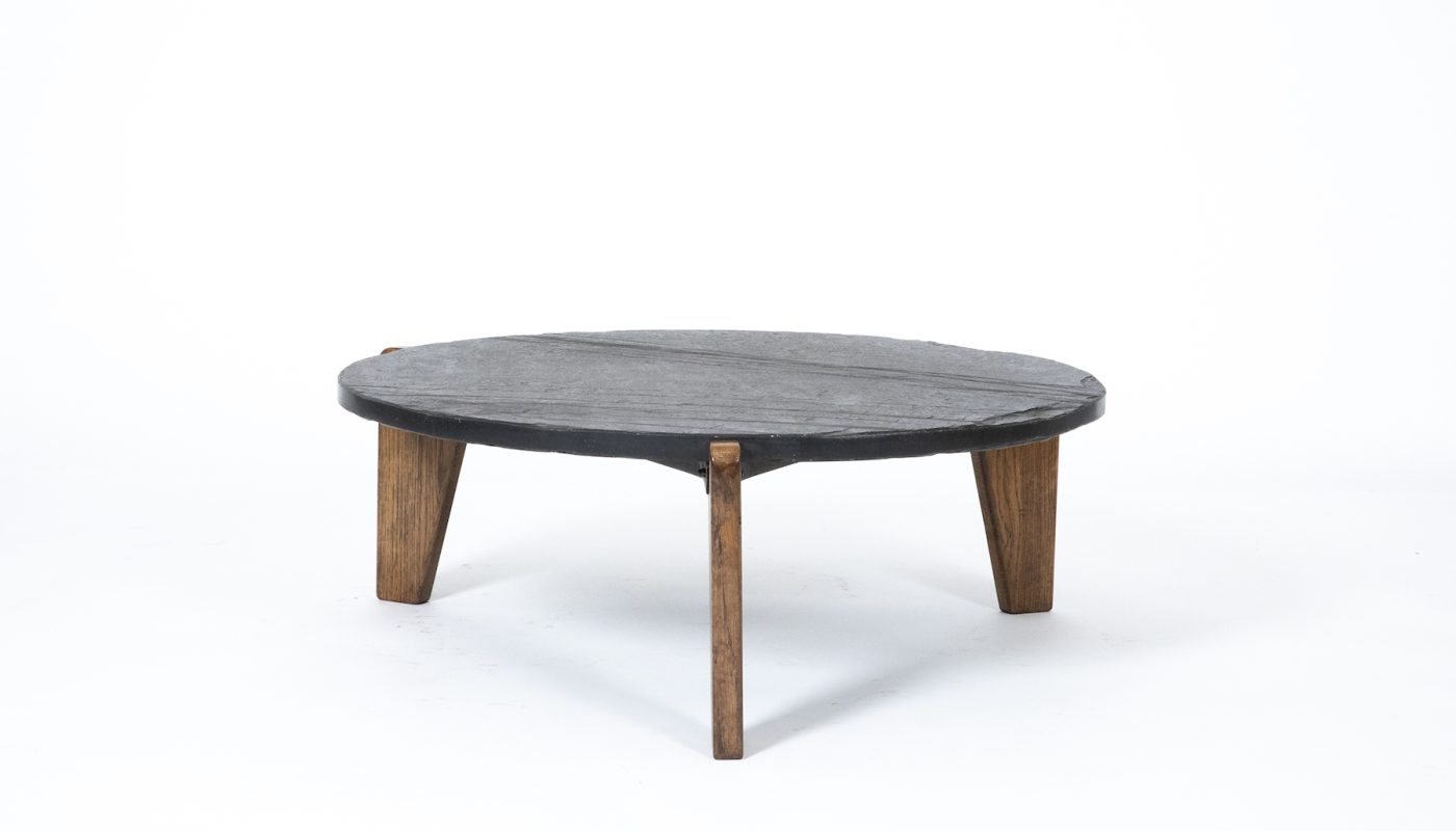 A slate-top JEAN PROUVÉ coffee table offered by MAGEN H GALLERY