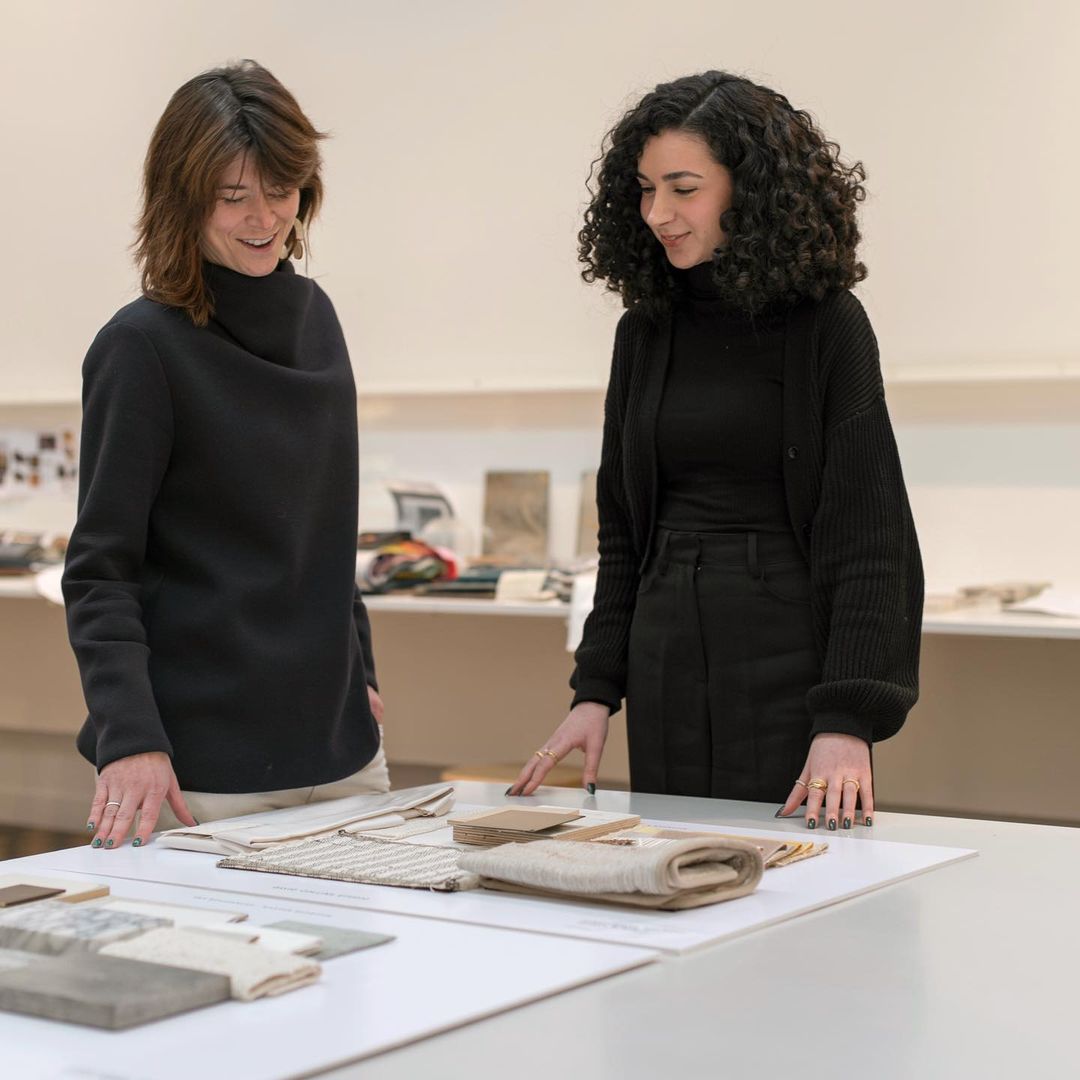 United in Design intern Derya Gul reviews swatches with a coworker at David Collins Studio. 