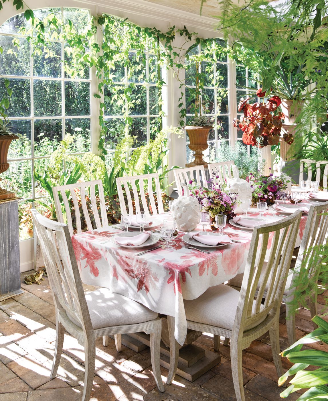 Pink and white tablescape in the garden conservatory of interior designer Bunny Williams in northwest Connecticut